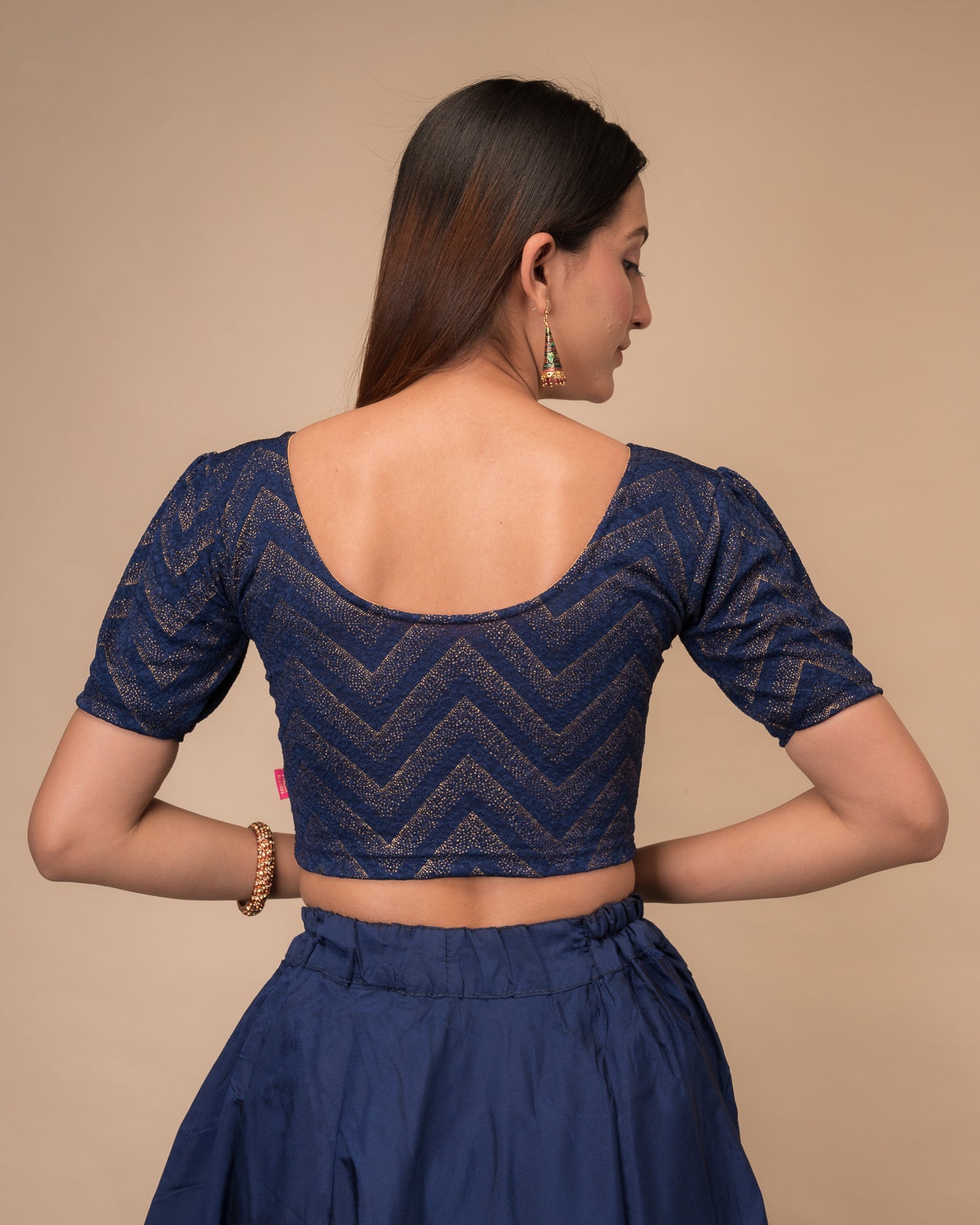 Rear view showcasing the slip-on design and ruffled shoulder detail