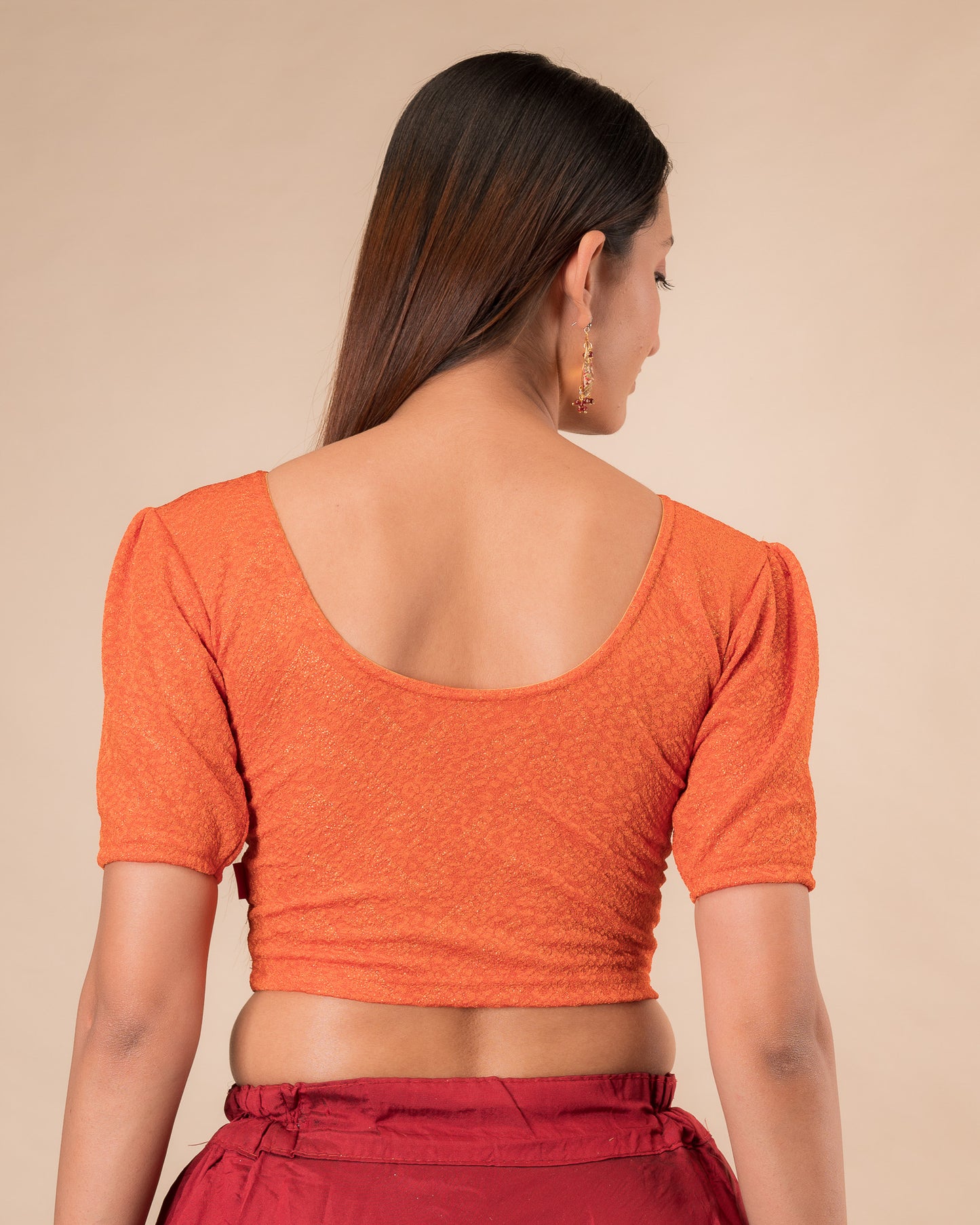 Rear view showcasing the slip-on design and ruffled shoulder detail