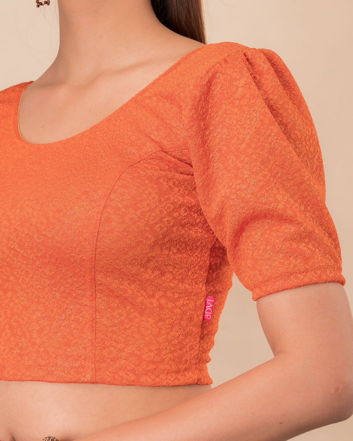 Close-up of the melange jacquard knit with subtle glitter and paisley pattern