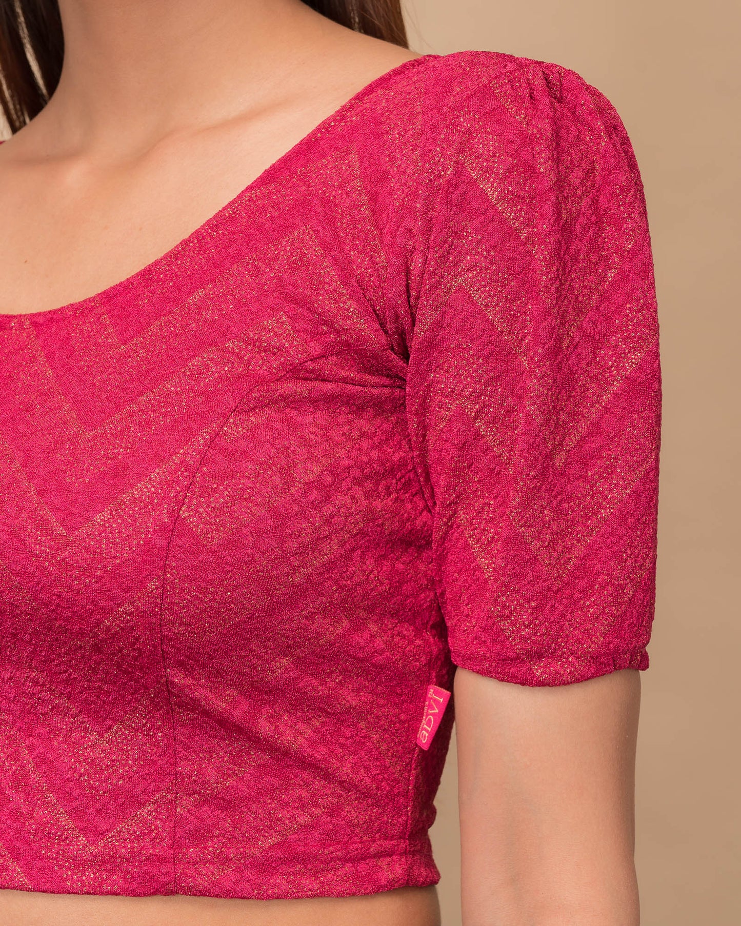 Close-up of the melange jacquard knit with subtle glitter and paisley pattern