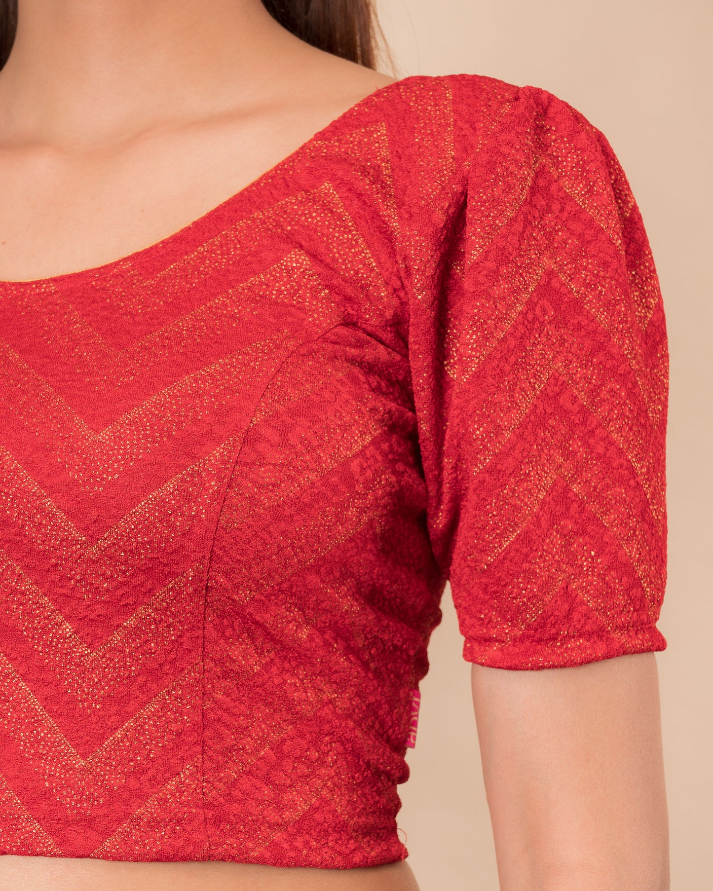 Close-up of the melange jacquard knit with subtle glitter and paisley pattern