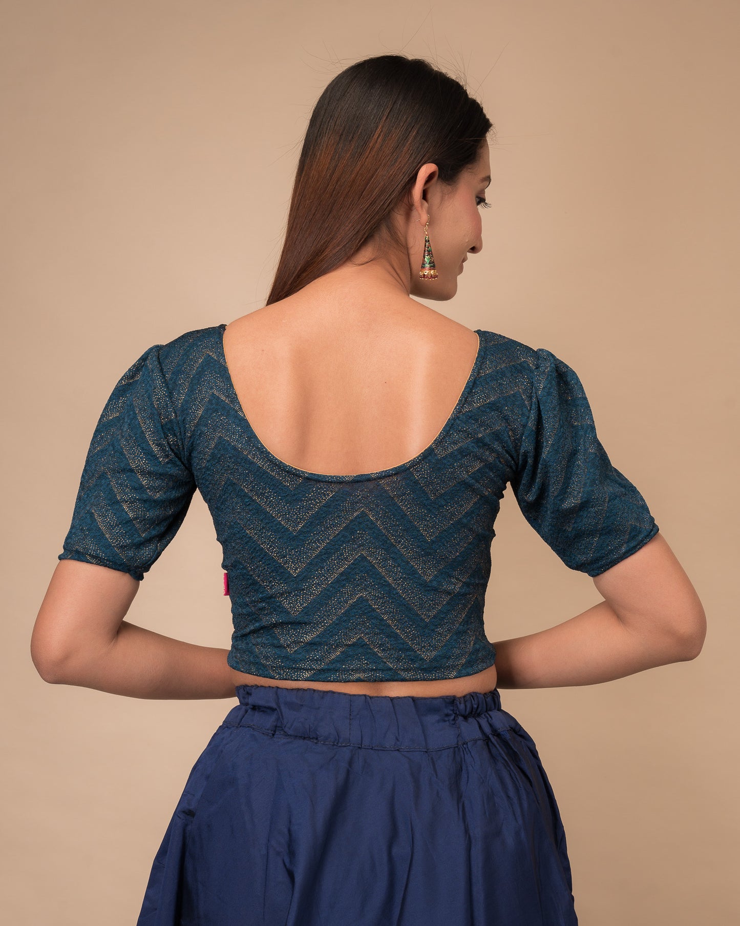 Rear view showcasing the slip-on design and ruffled shoulder detail