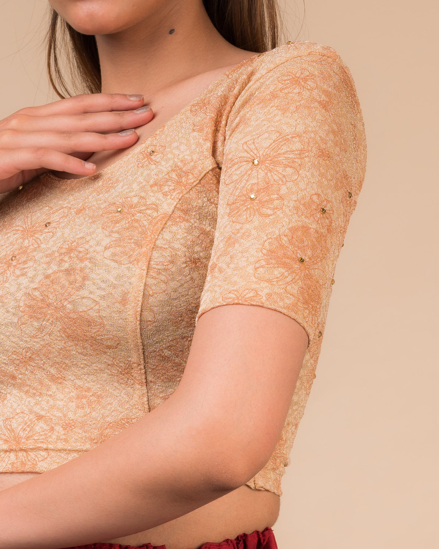Close-up detailing the floral foil texture and stone work on jacquard fabric