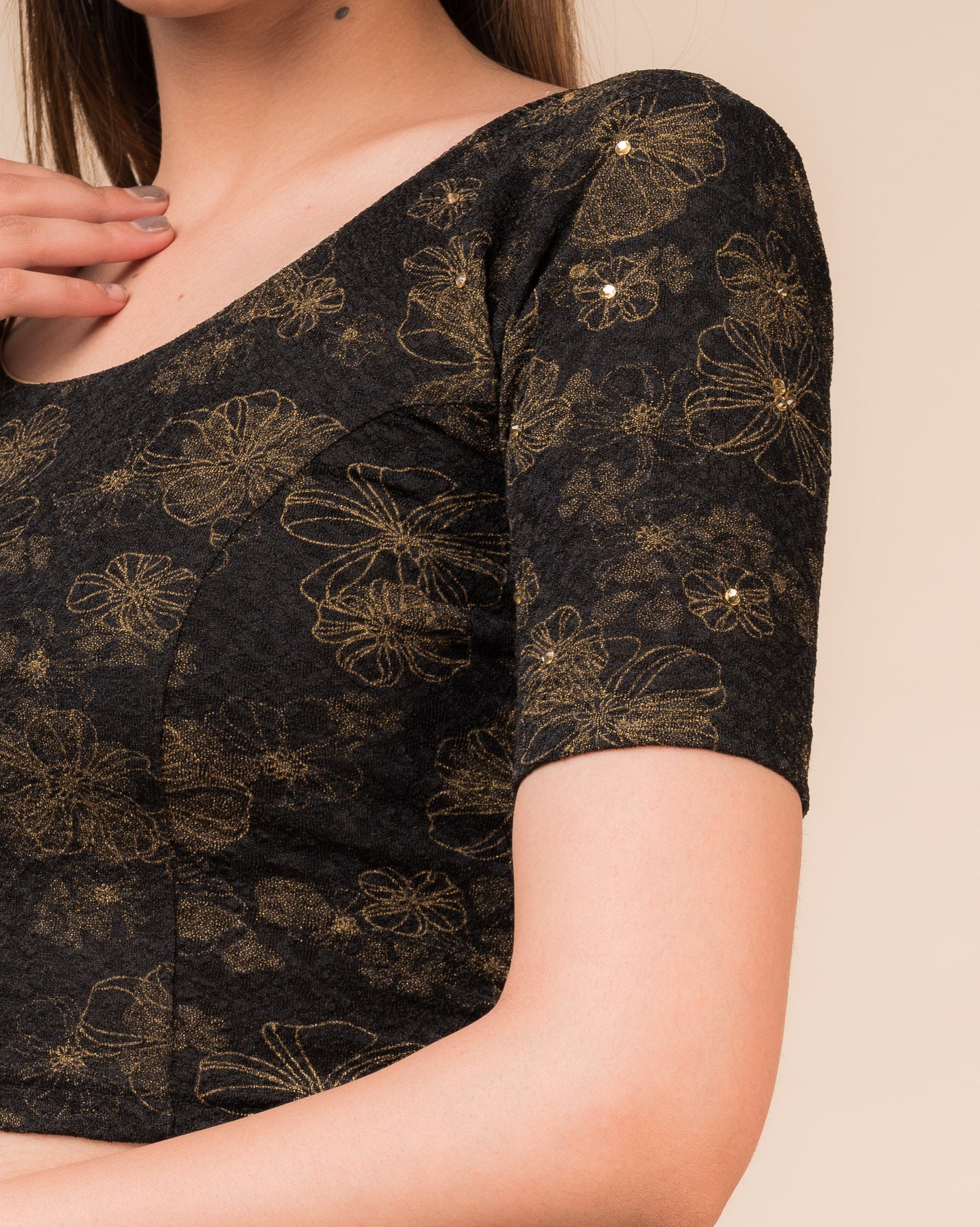 Close-up detailing the floral foil texture and stone work on jacquard fabric