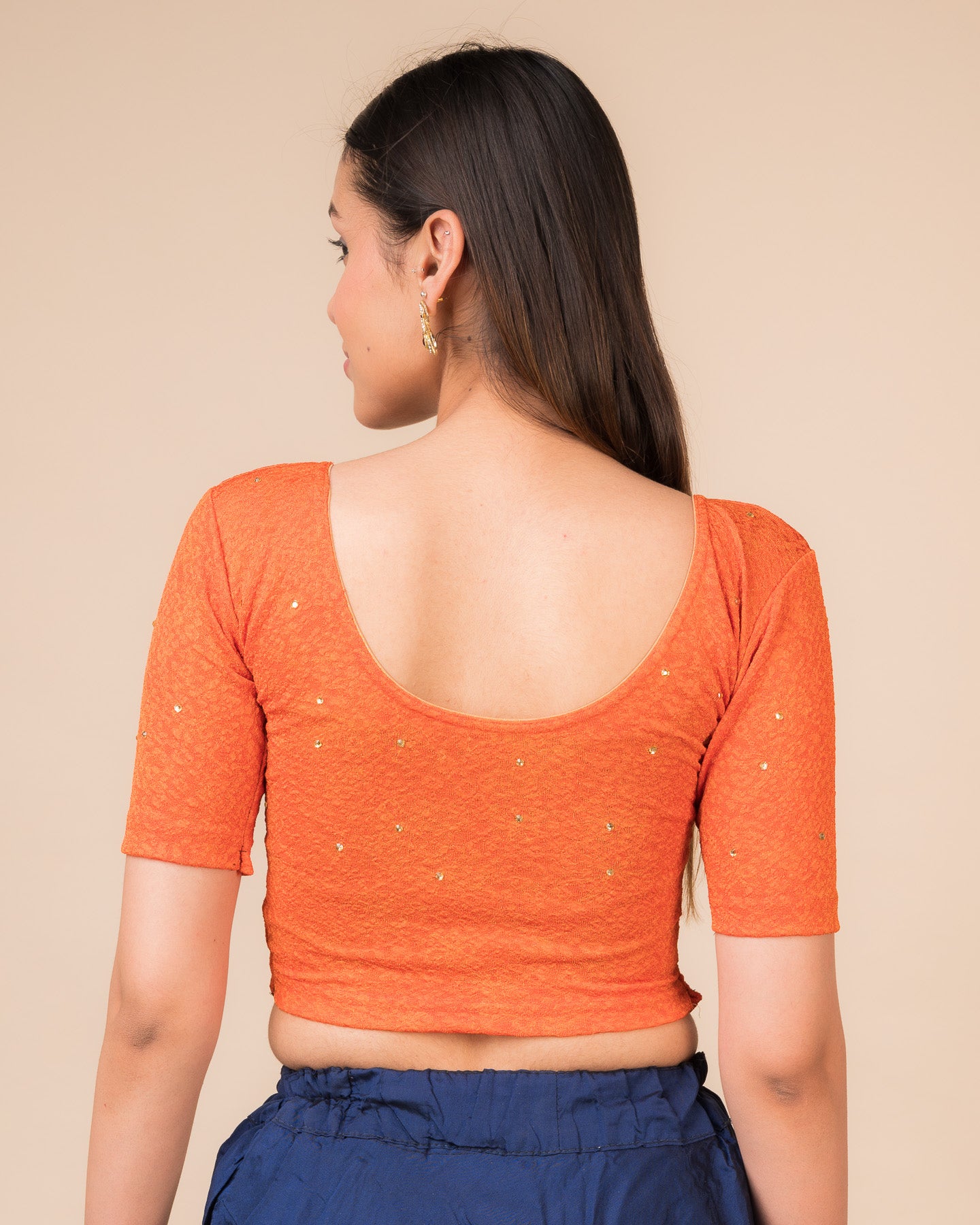 Rear view showcasing the back design texture and embellishments