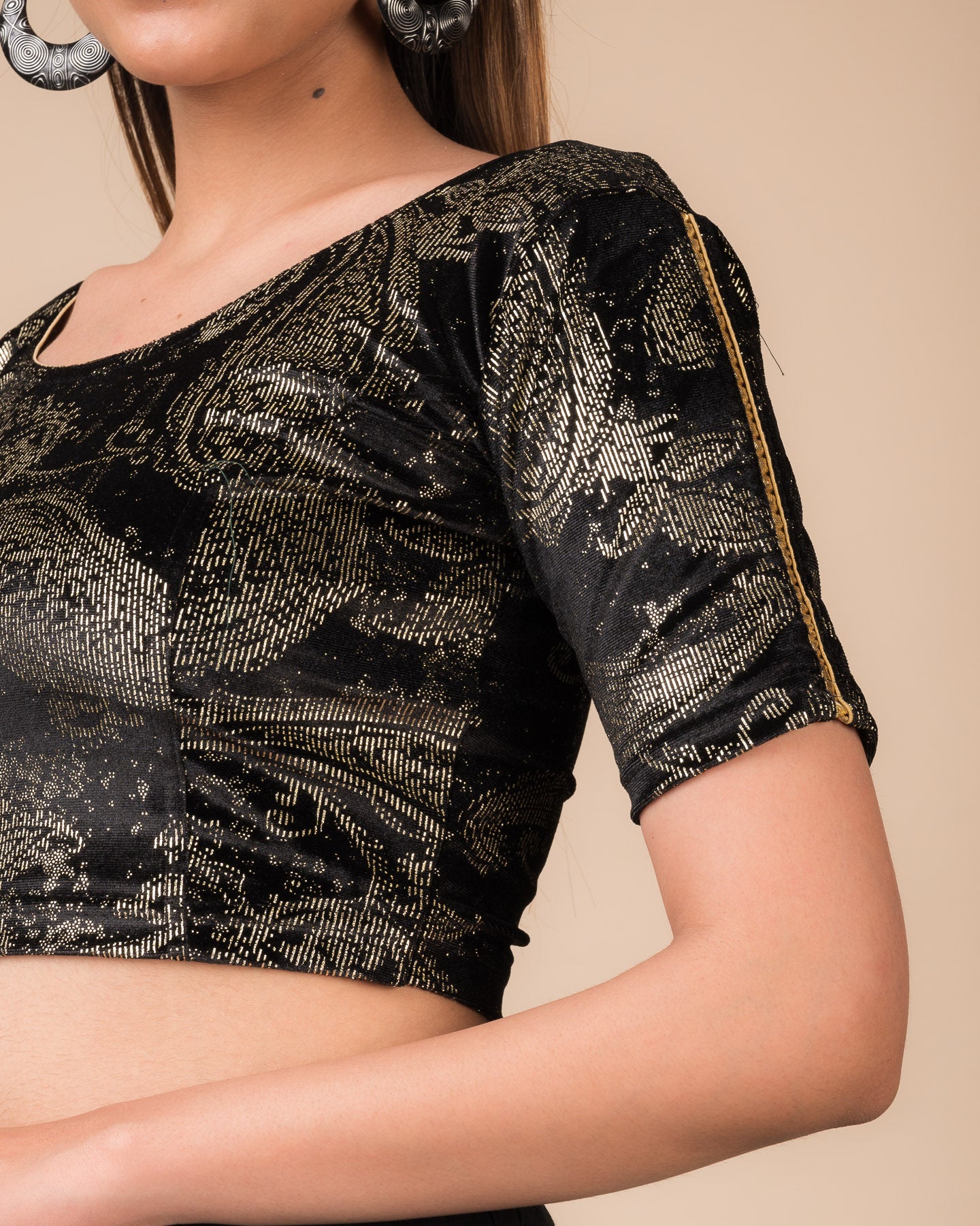 Close-up of velvet texture with gold paisley prints and gota accents