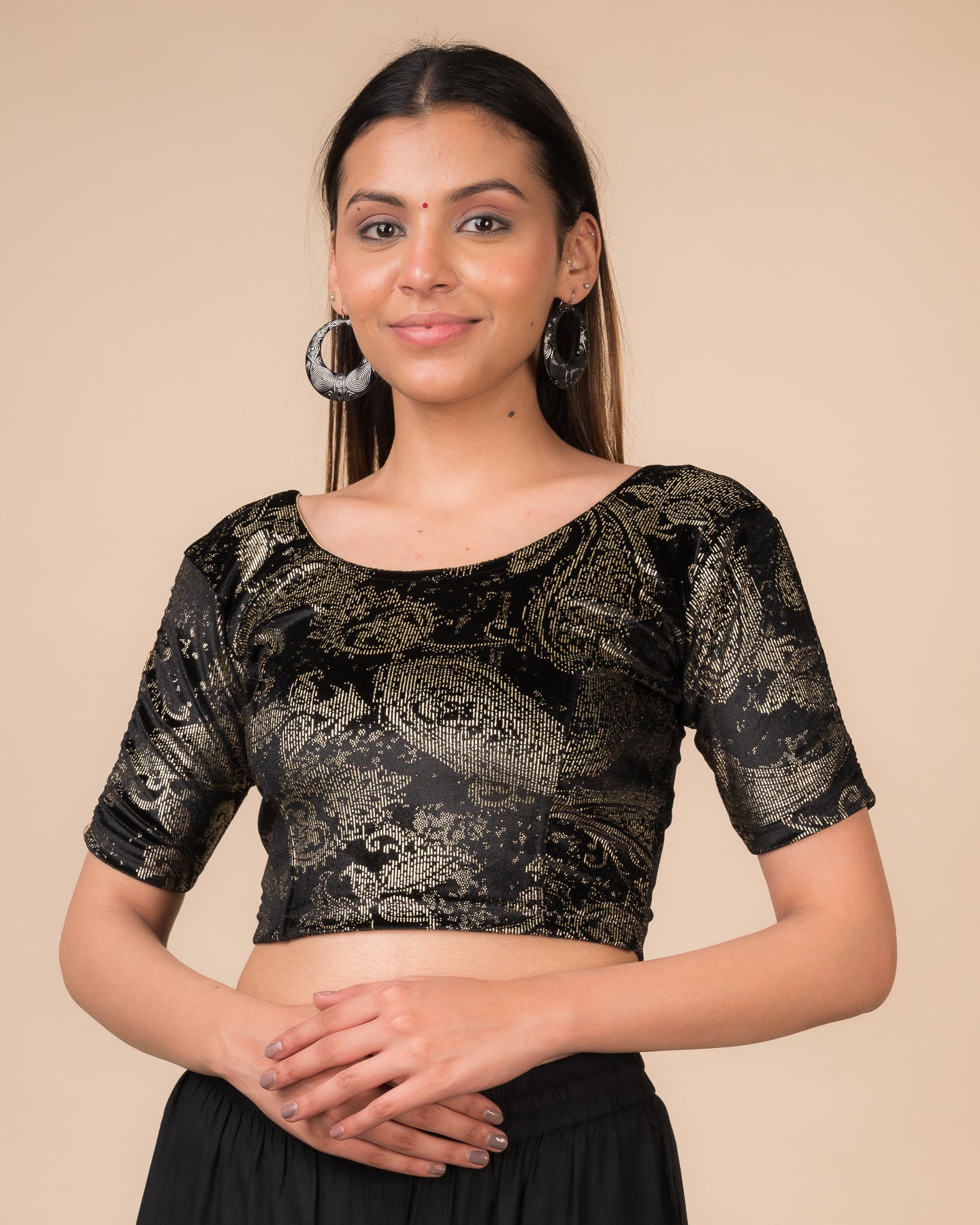 Model wearing a maroon velvet stretchable blouse with gold paisley prints, elbow sleeves, and round neckline.