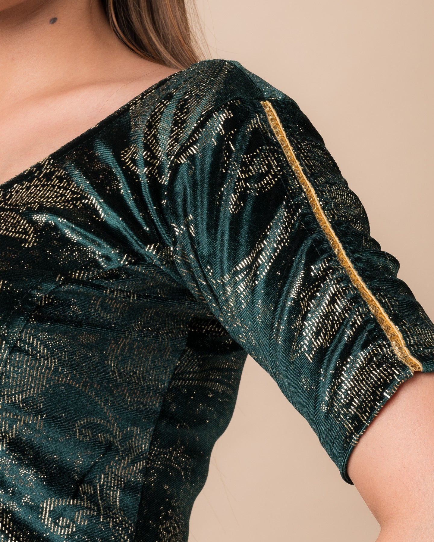 Close-up of velvet texture with gold paisley prints and gota accents