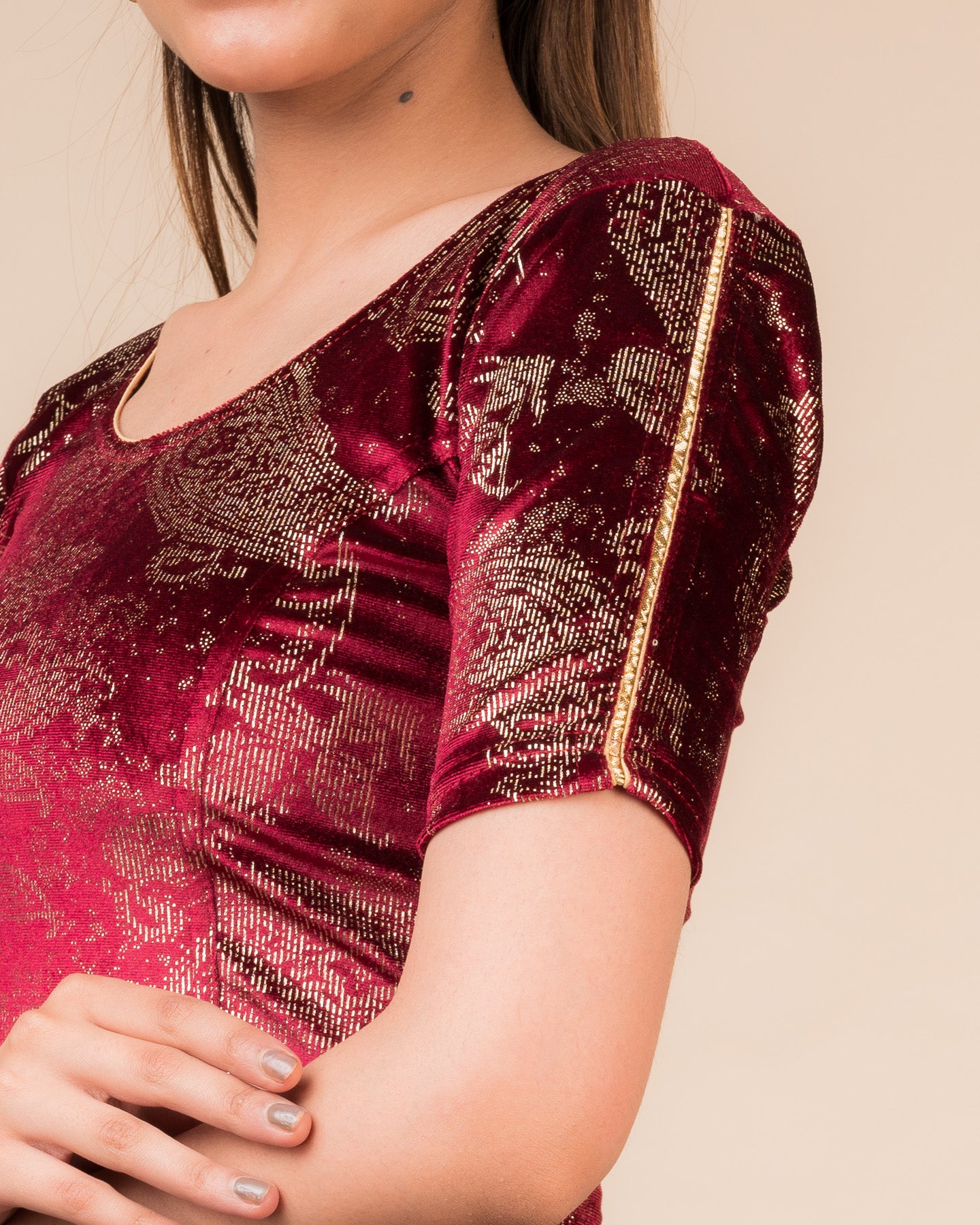 Close-up of velvet texture with gold paisley prints and gota accents