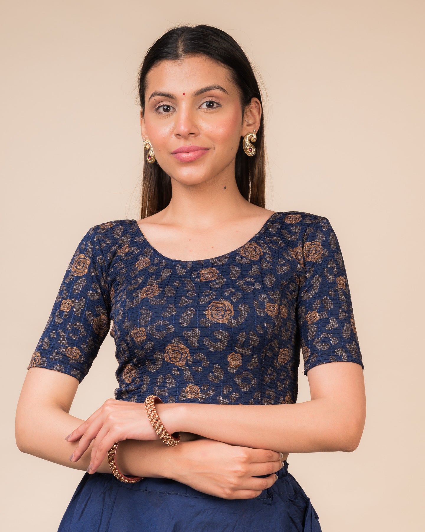 Model wearing a red stretchable blouse with metallic foil floral print, elbow sleeves, and round neckline