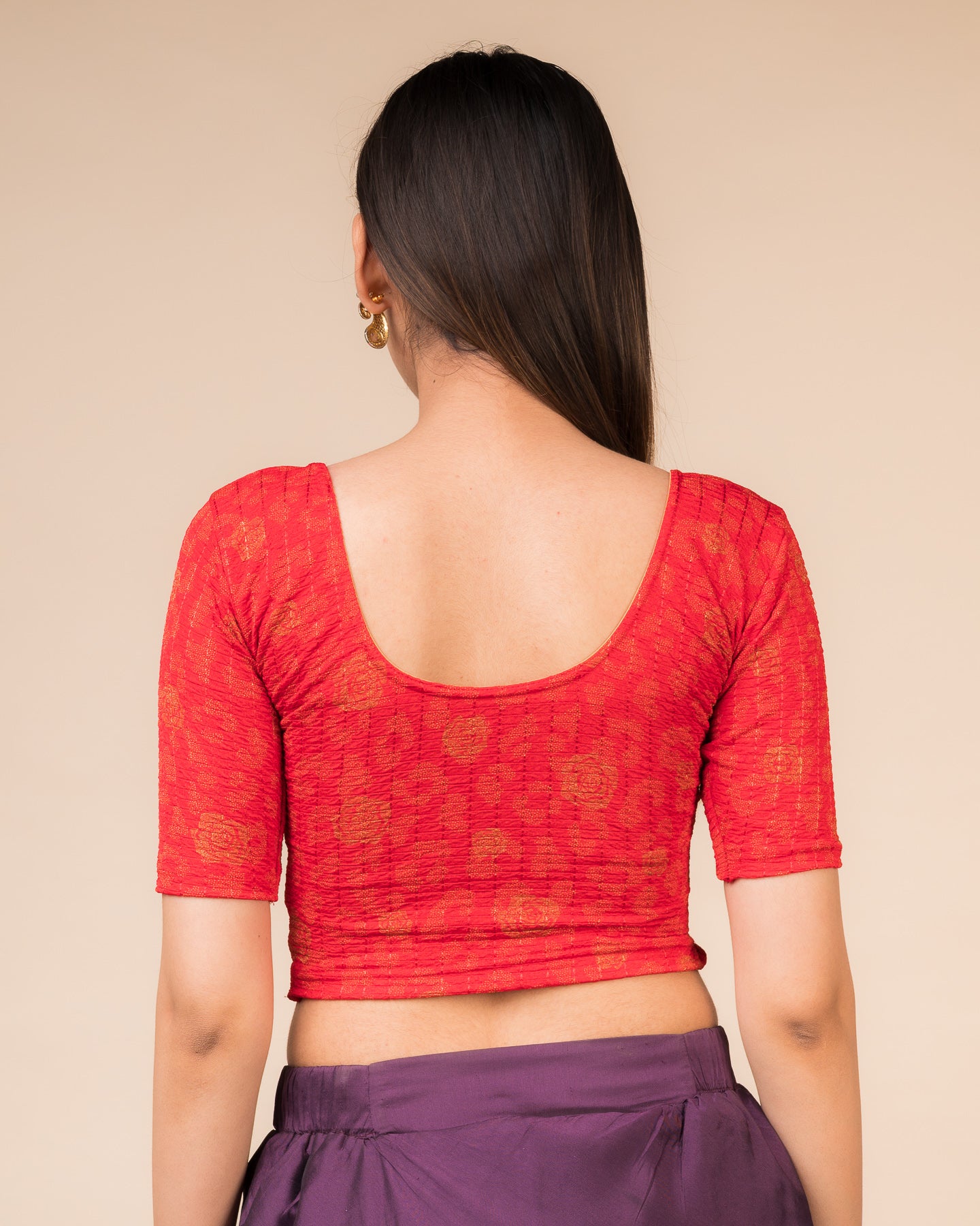 Rear view showcasing the blouse’s slip-on design and back texture