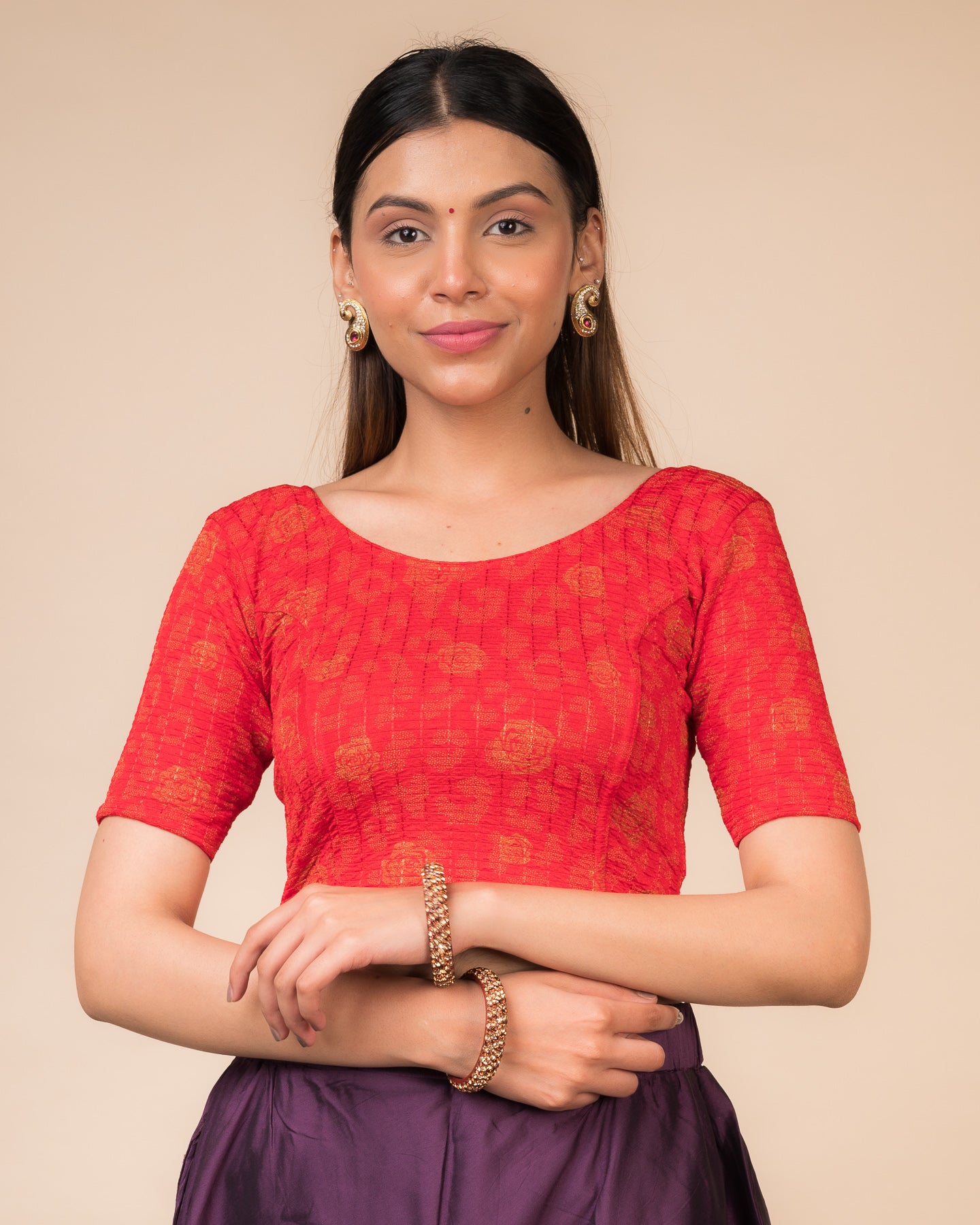 Model wearing a red stretchable blouse with metallic foil floral print, elbow sleeves, and round neckline