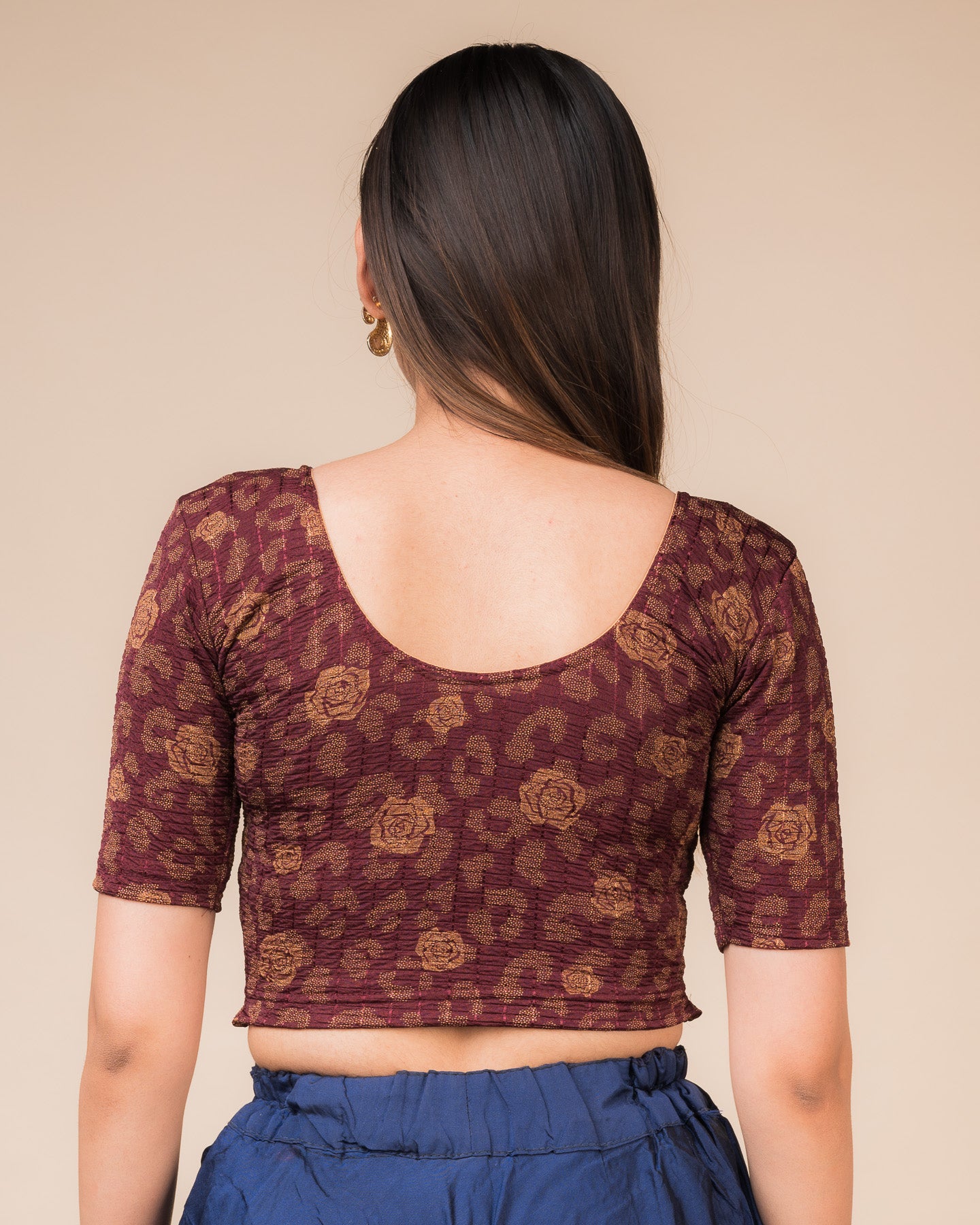 Rear view showcasing the blouse’s slip-on design and back texture