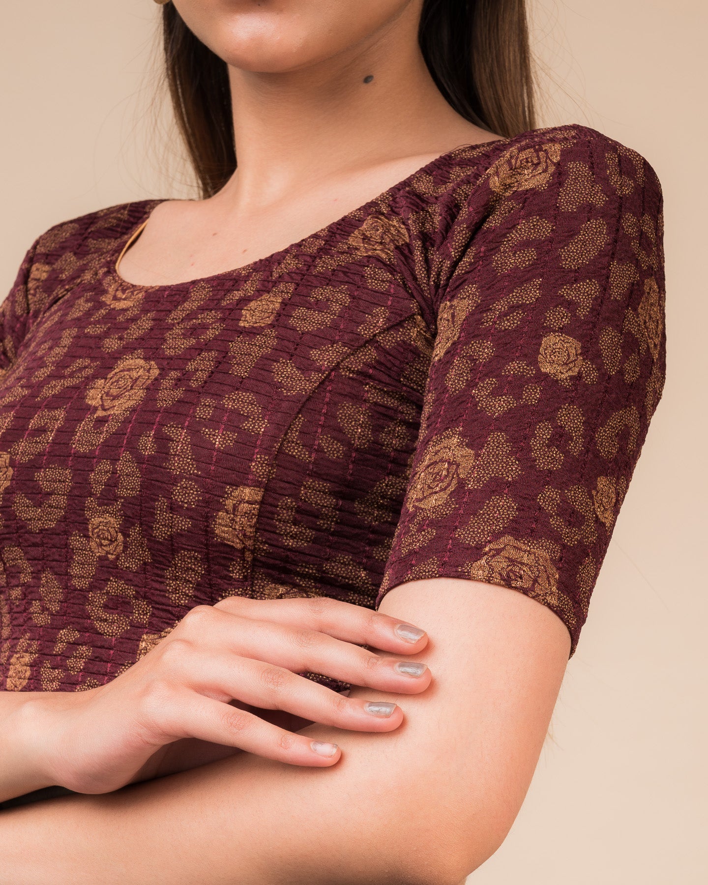 Close-up of the fabric’s metallic floral foil design and stretchable texture