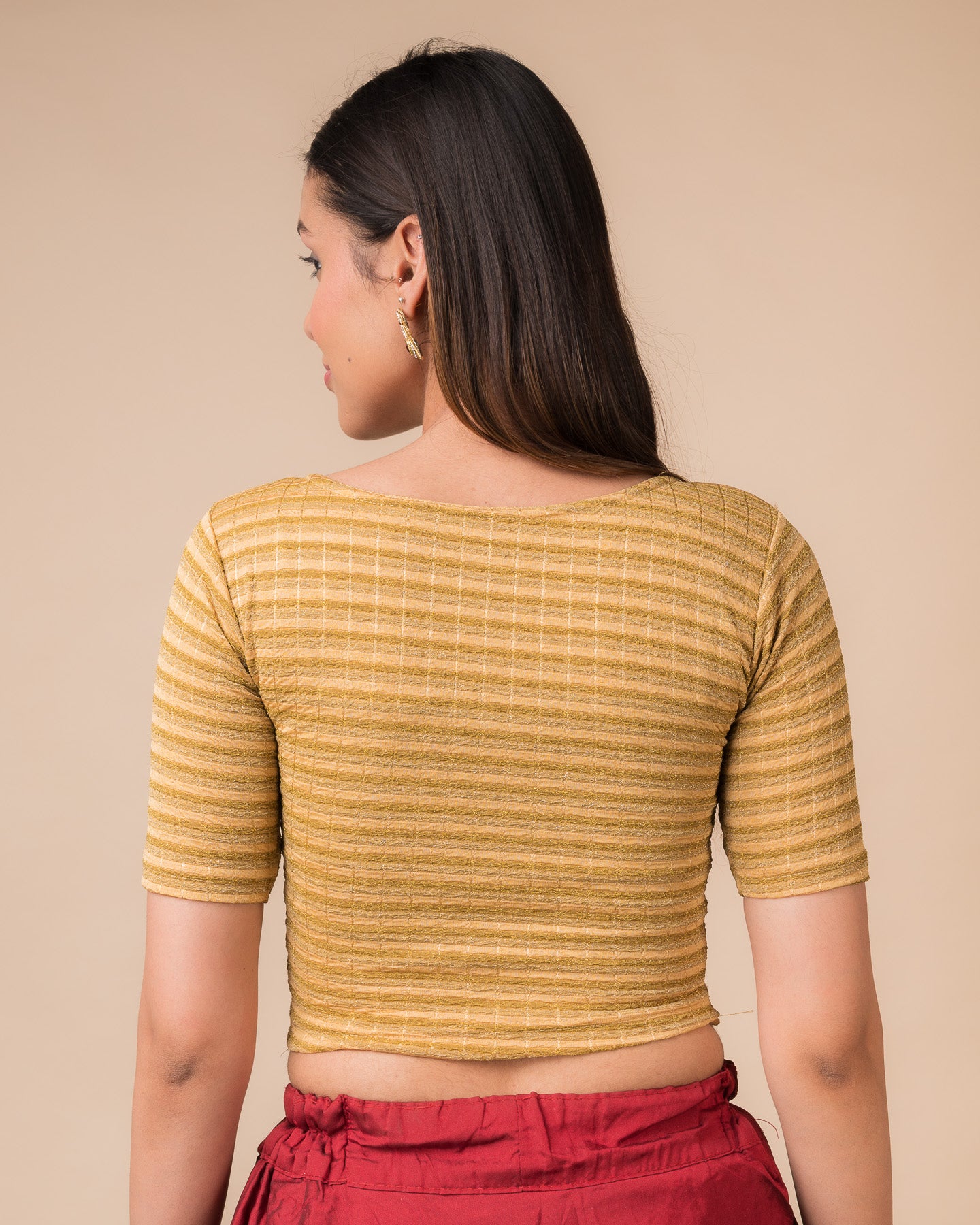 Rear view showcasing the back design of the metallic stripe blouse
