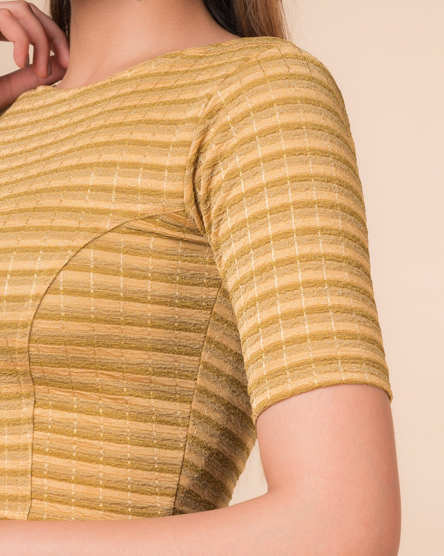 Close-up of the jacquard fabric detailing the gold and silver stripes