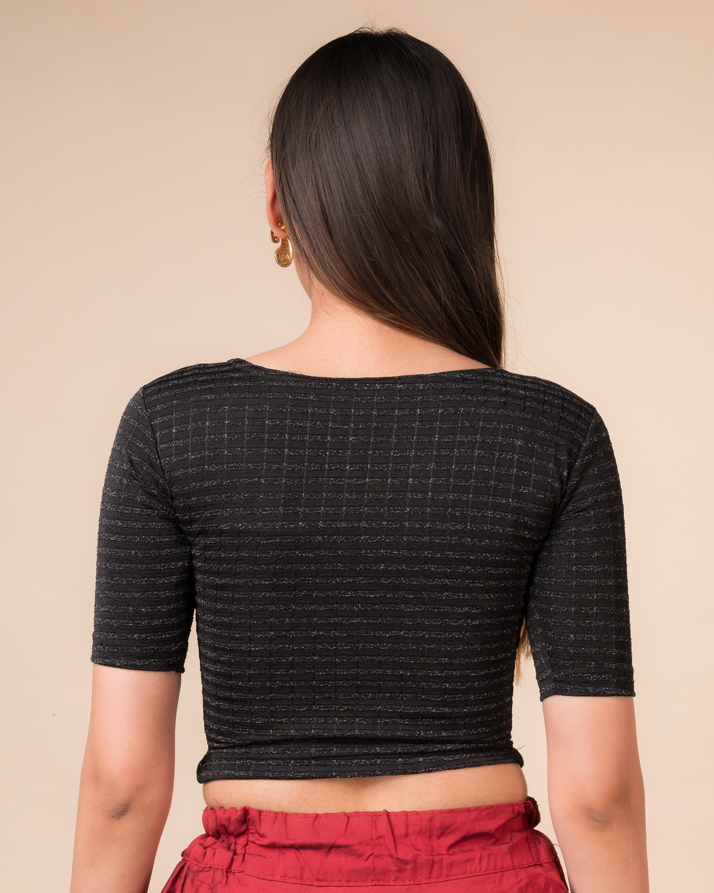 Rear view showcasing the back design of the metallic stripe blouse