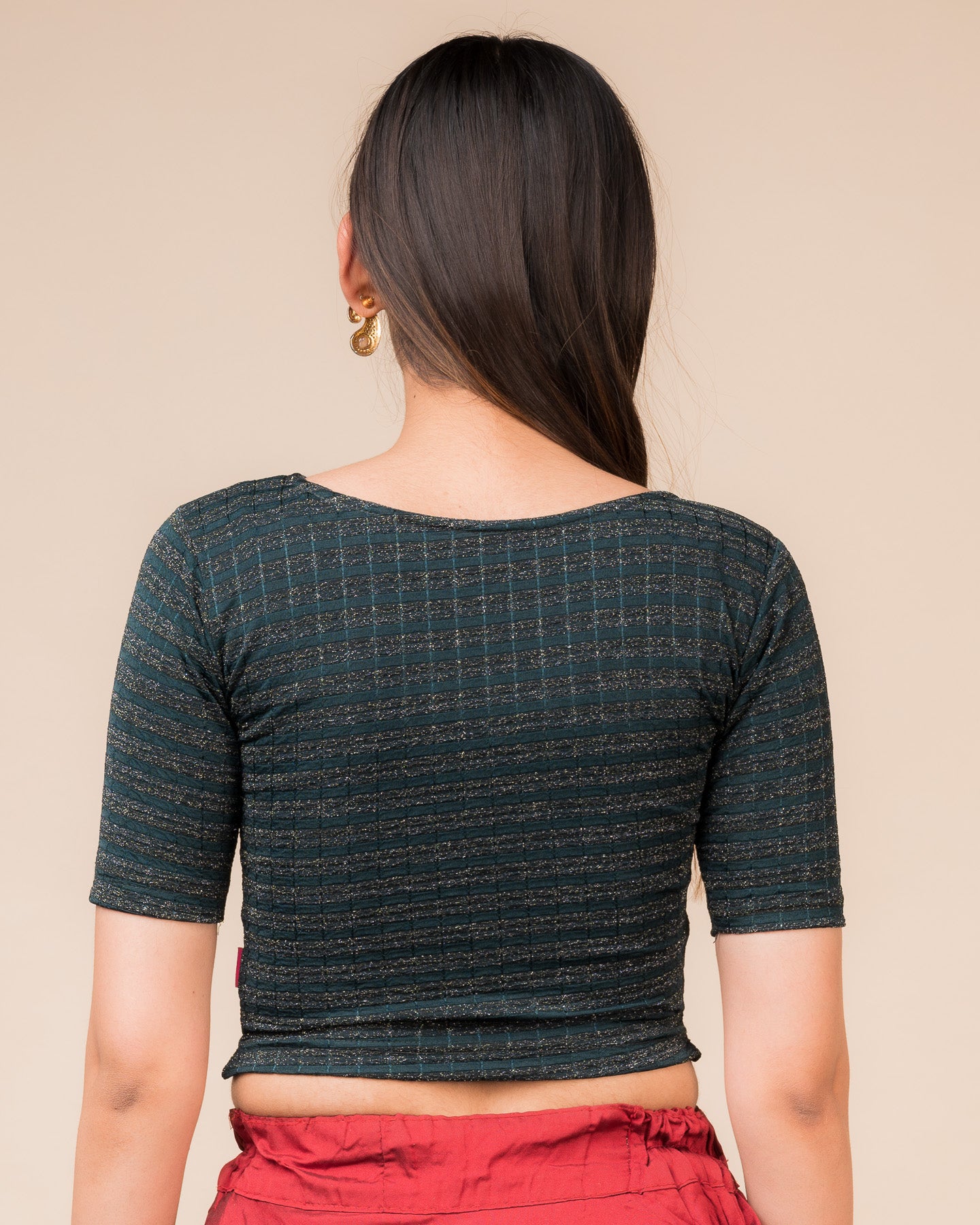 Rear view showcasing the back design of the metallic stripe blouse