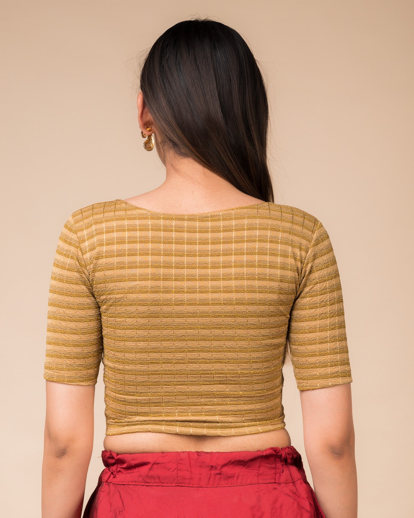 Rear view showcasing the back design of the metallic stripe blouse