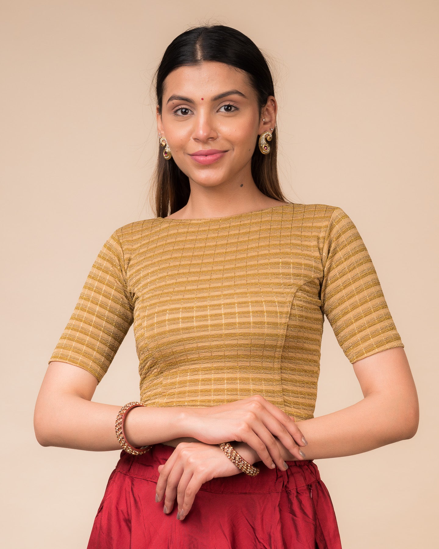 Model wearing a metallic-striped stretchable blouse with elbow sleeves and boat neckline