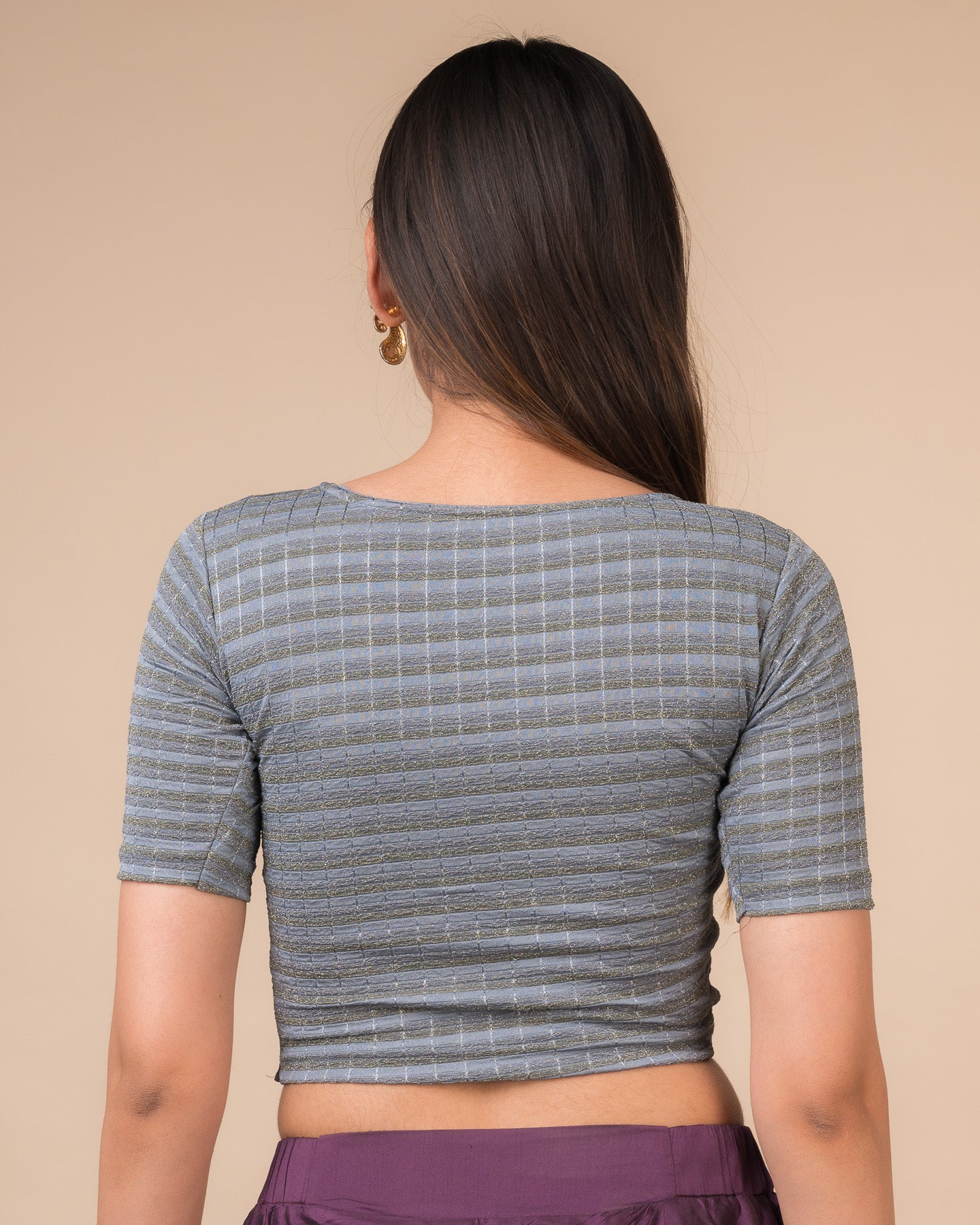 Rear view showcasing the back design of the metallic stripe blouse