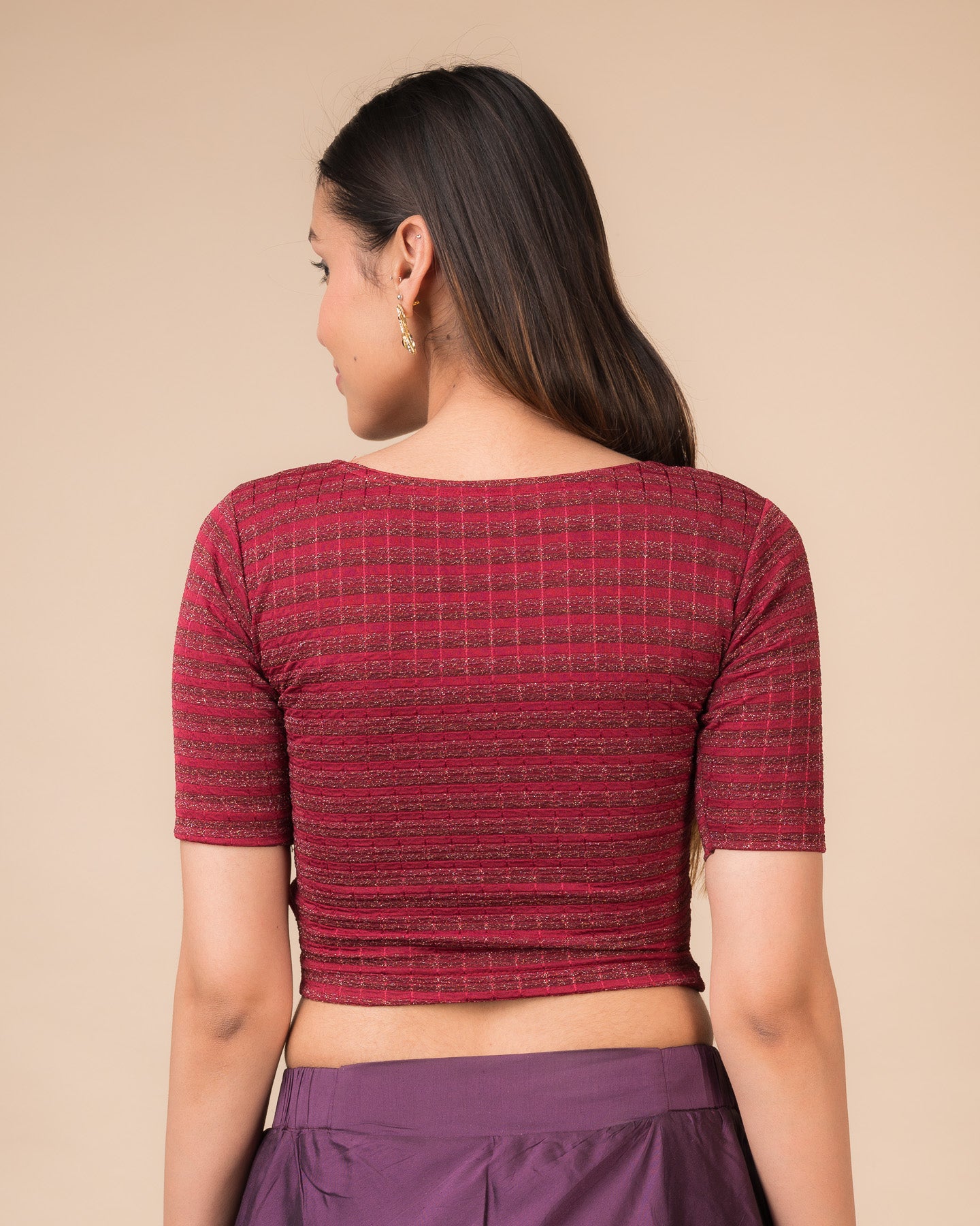 Rear view showcasing the back design of the metallic stripe blouse