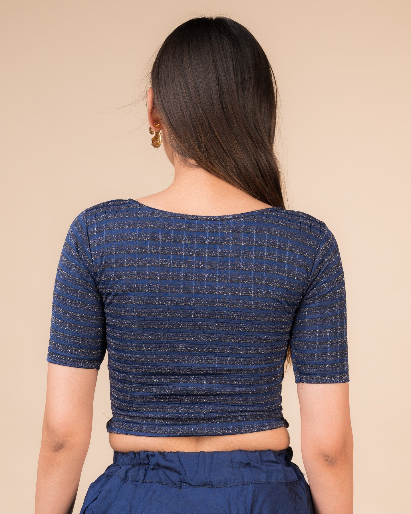 Rear view showcasing the back design of the metallic stripe blouse