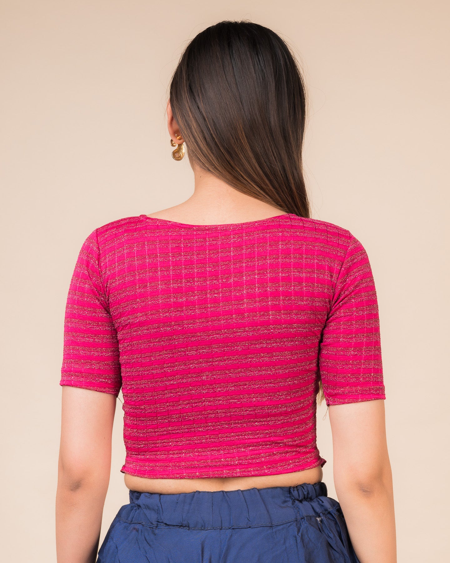 Rear view showcasing the back design of the metallic stripe blouse