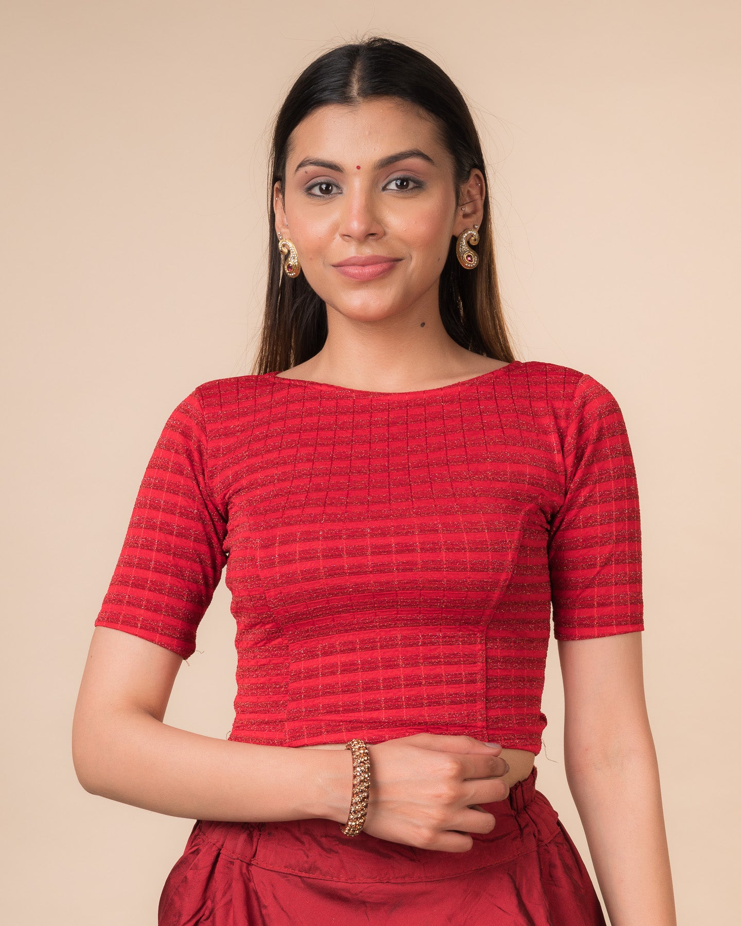 Model wearing a metallic-striped stretchable blouse with elbow sleeves and boat neckline