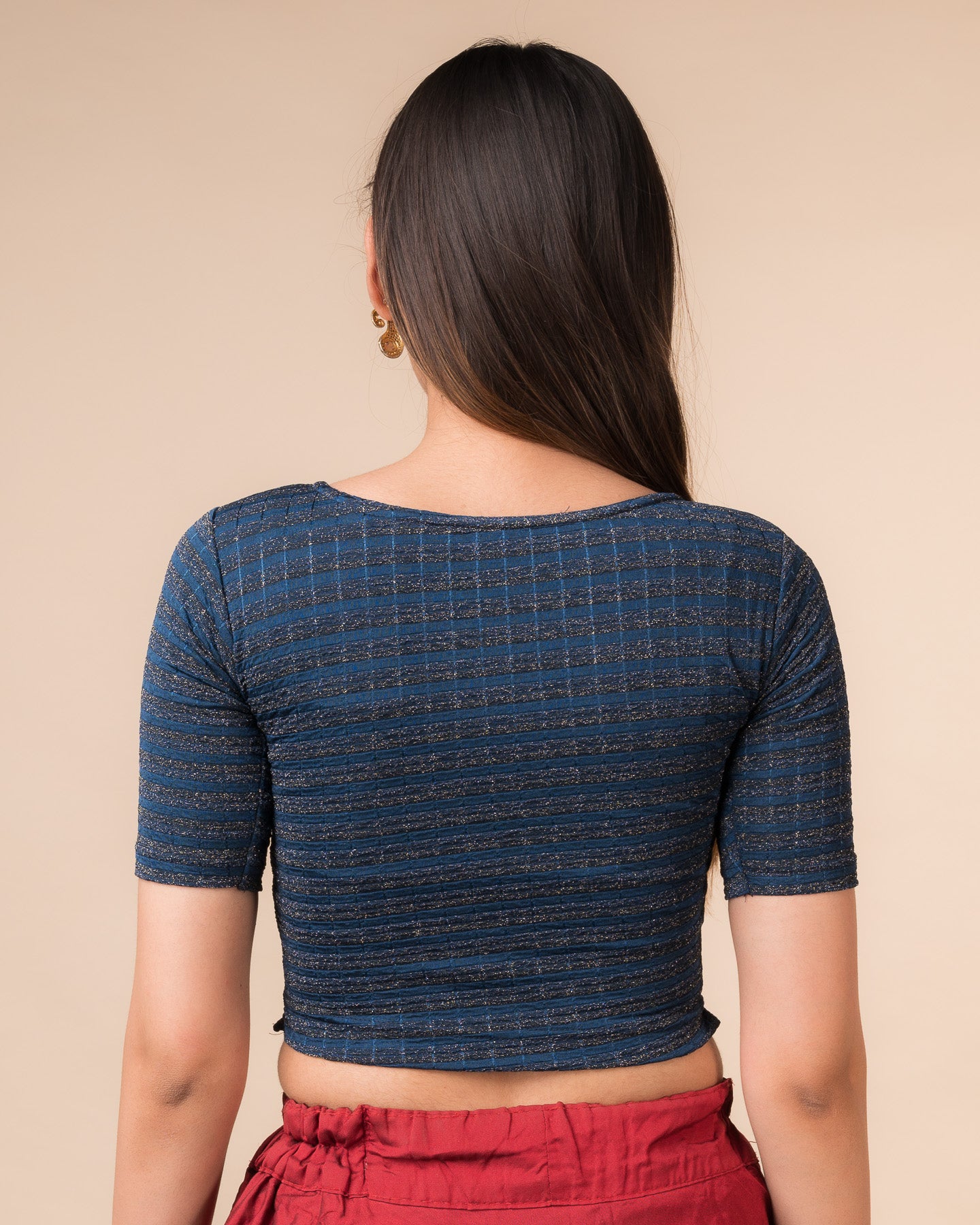 Rear view showcasing the back design of the metallic stripe blouse