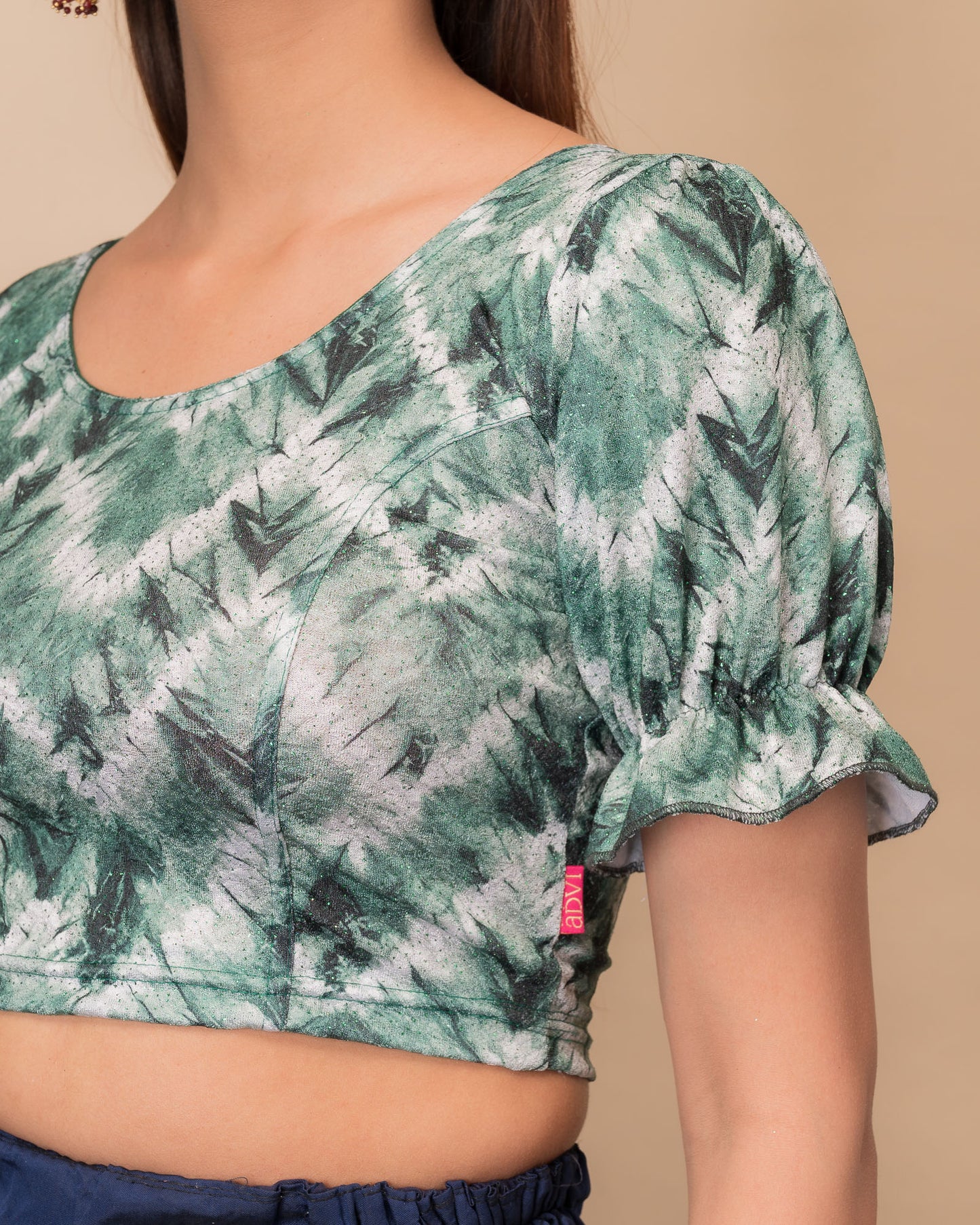 Close-up of the shibori tie-dye fabric with subtle glitter and knitted texture