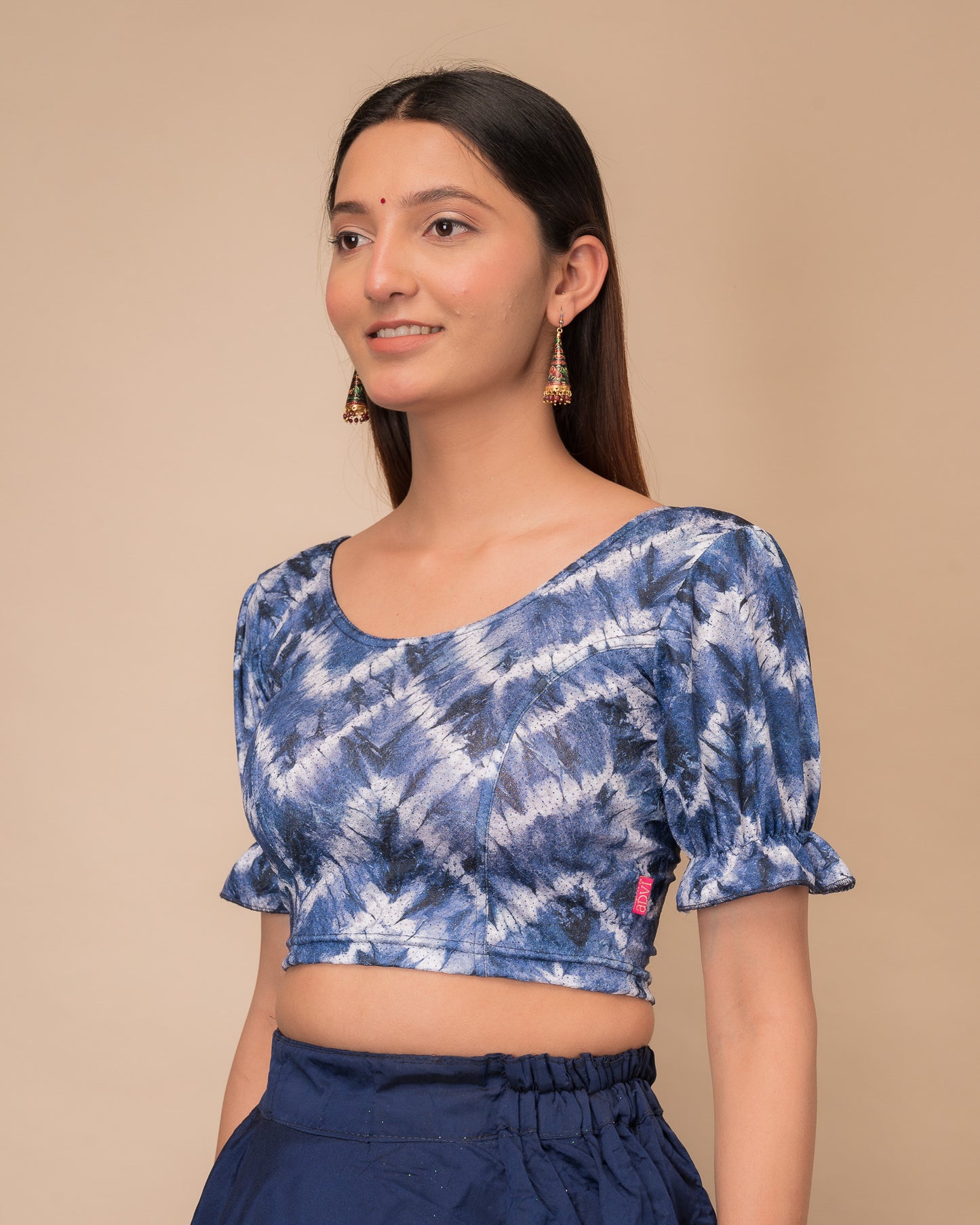 Side profile highlighting the fit, pleated sleeve detail, and tie-dye texture