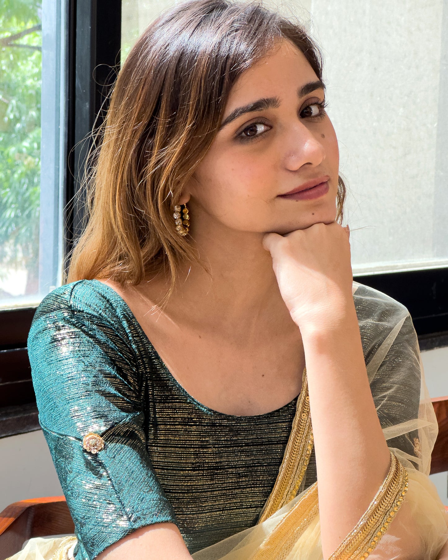 Model pairing the blouse with a festive saree for an ethnic look