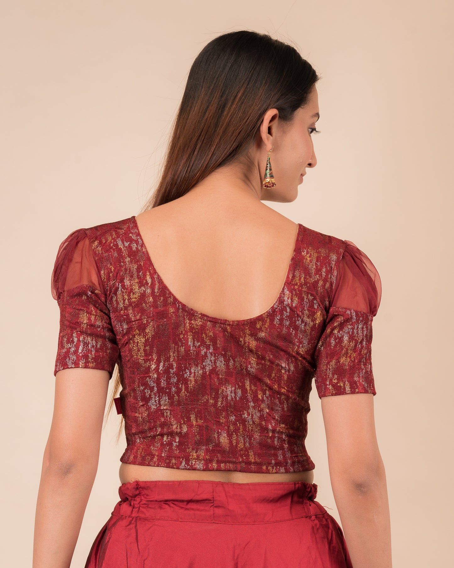 Rear view showing the blouse’s opaque bodice and puffed organza sleeves