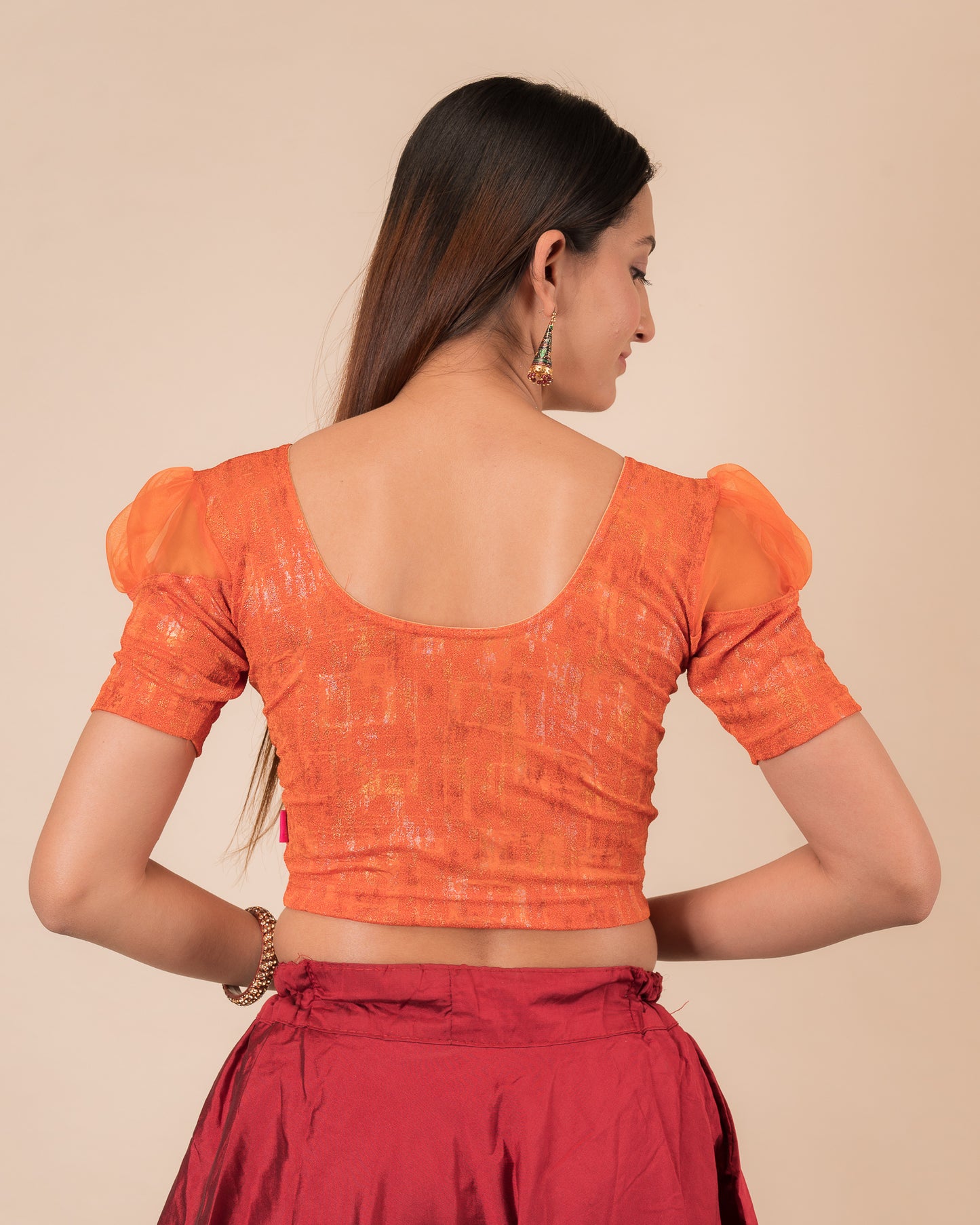 Rear view showing the blouse’s opaque bodice and puffed organza sleeves