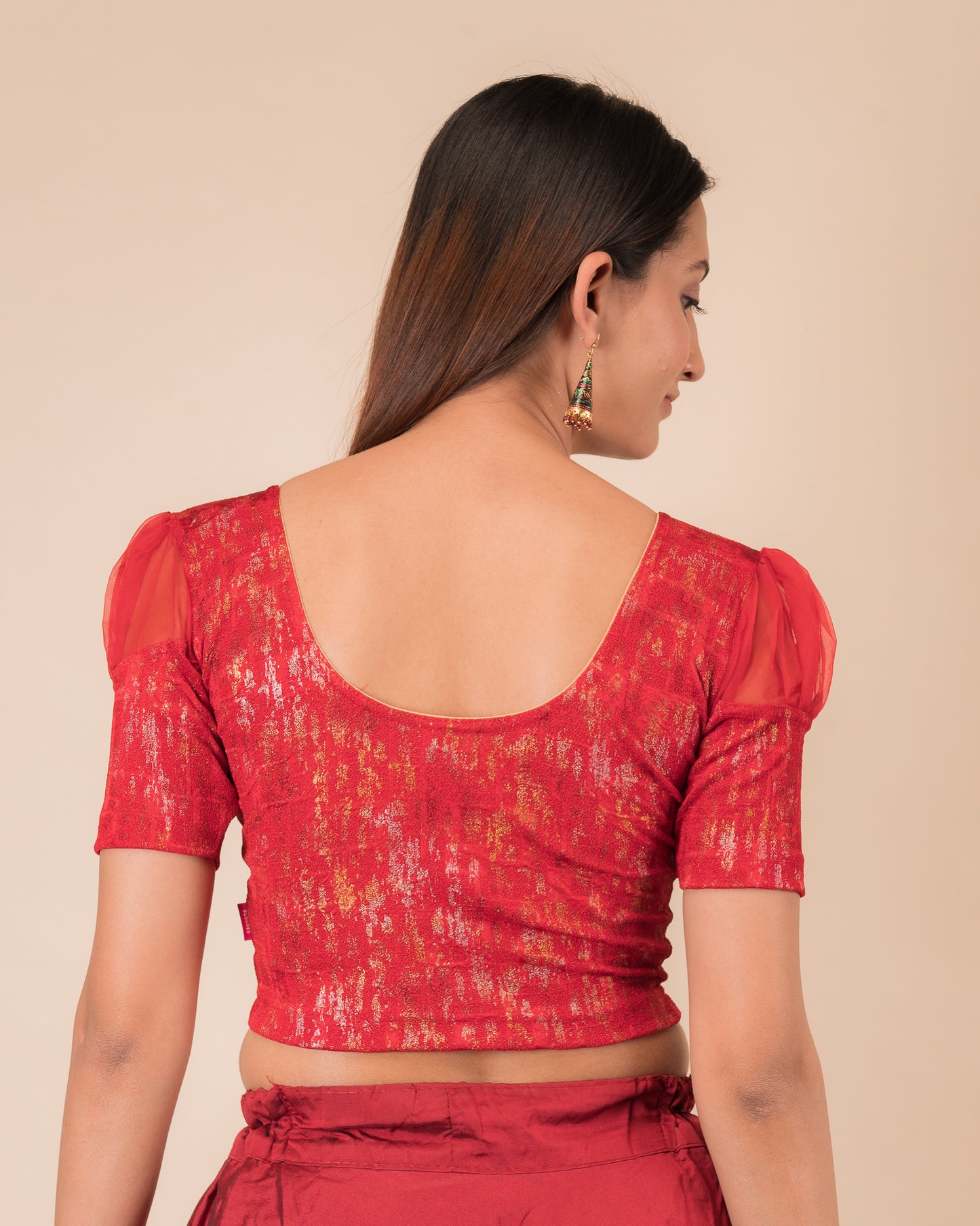 Rear view showing the blouse’s opaque bodice and puffed organza sleeves