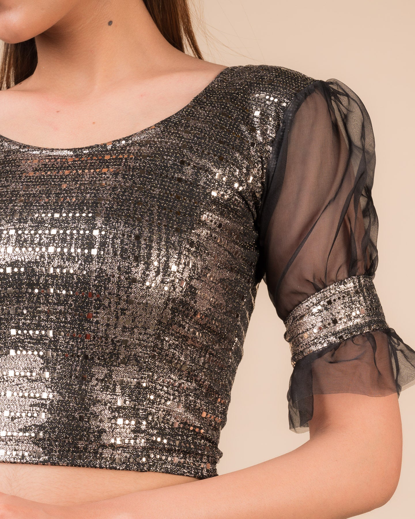 Close-up of the black metallic knit fabric showing its texture and stretchability