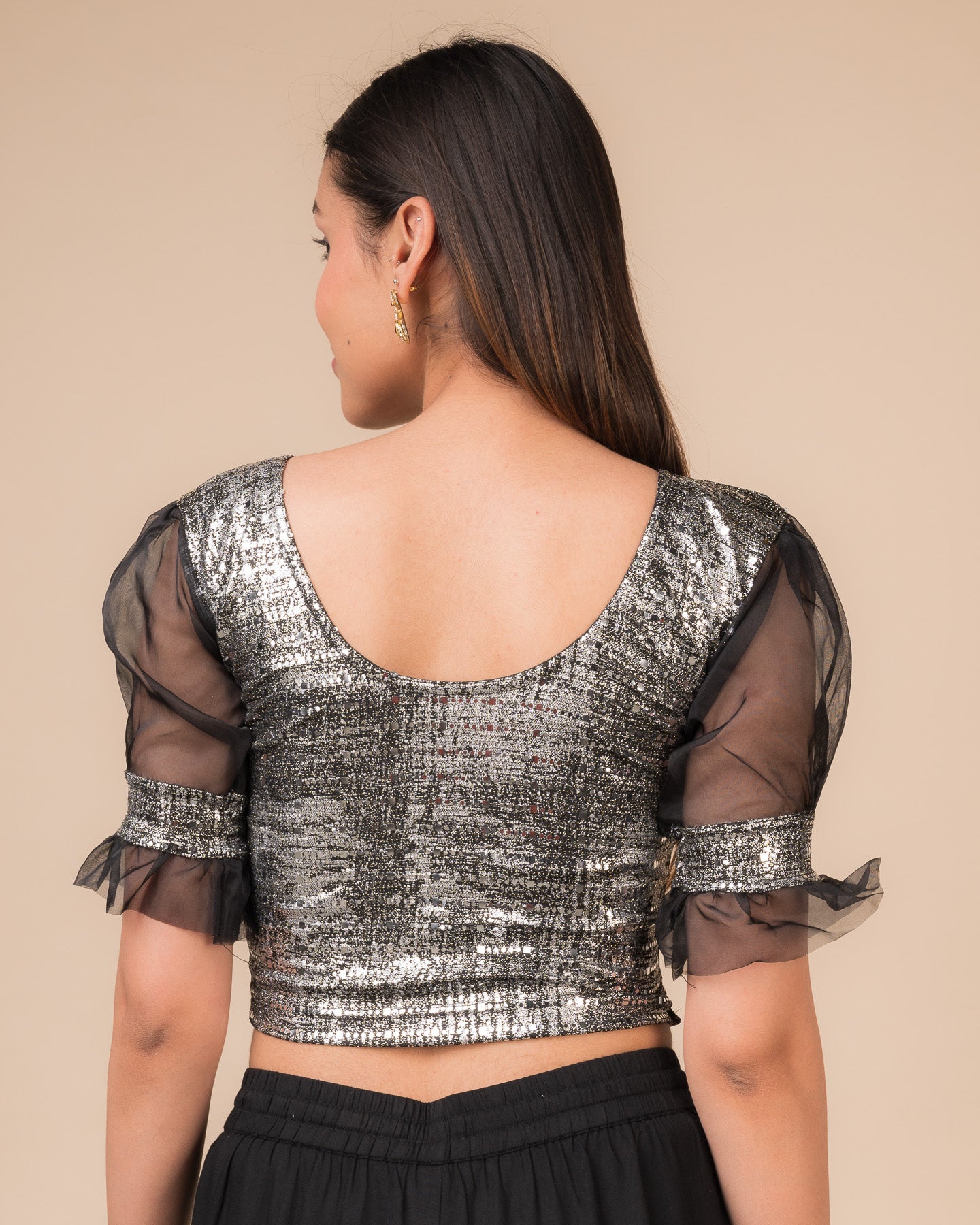 Rear view of the black metallic stretchable blouse showing a rounded back design.