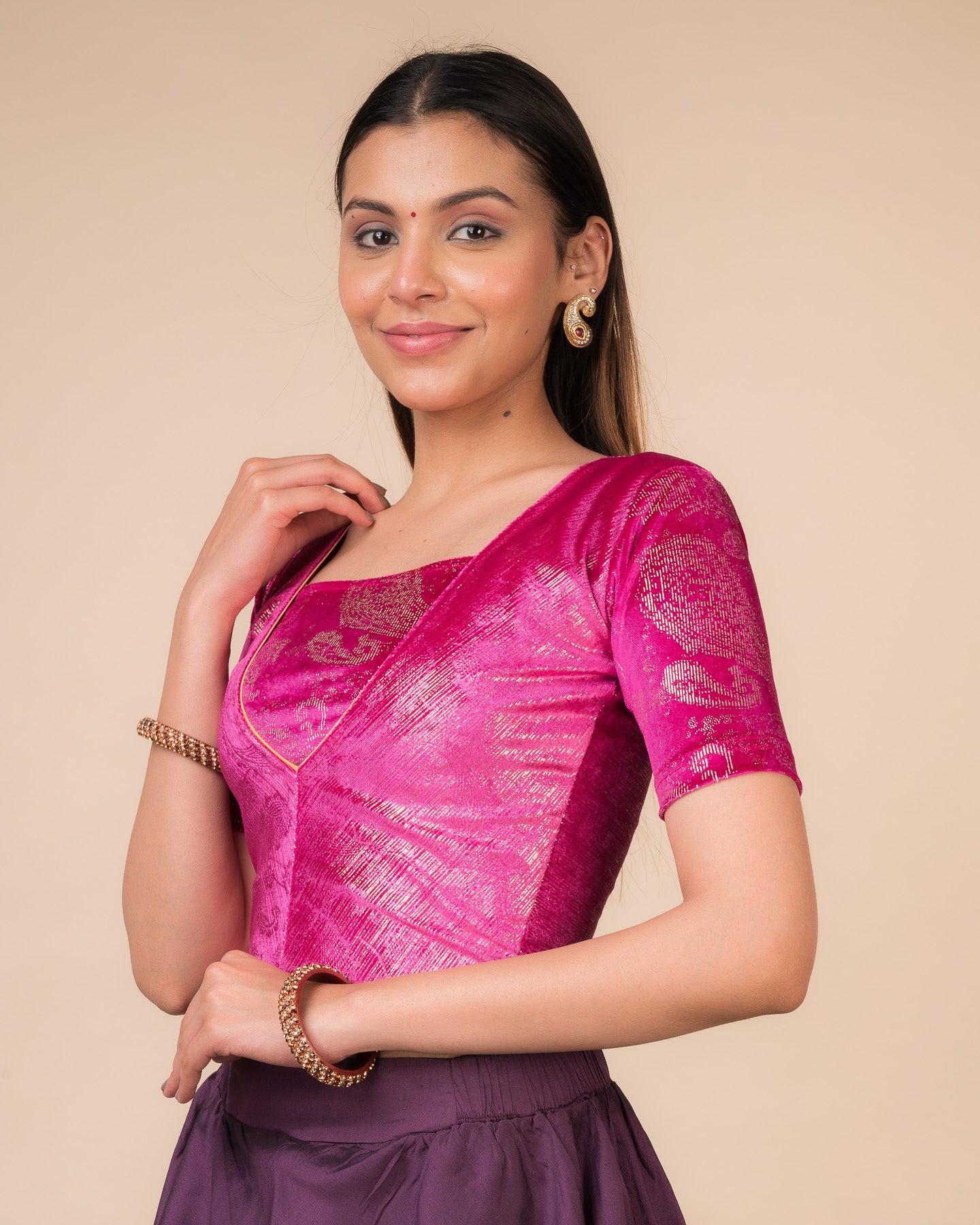 Side profile of the wine-colored velvet embellished stretchable choli-style blouse highlighting the fit and sleeve length.
