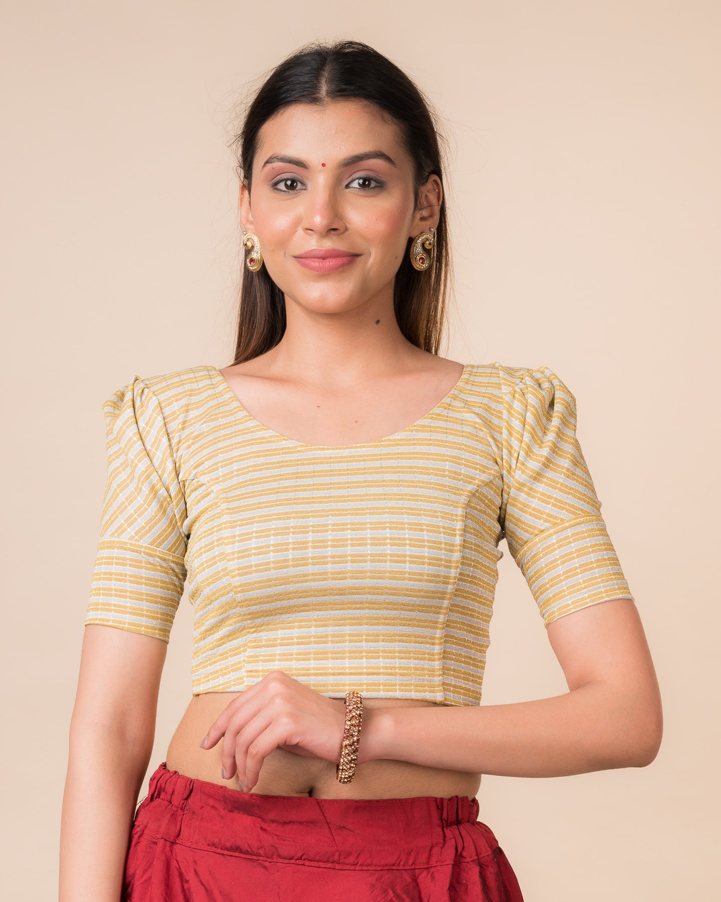 Model wearing a zari double-stripe stretchable readymade blouse with puff elbow sleeves and round neckline