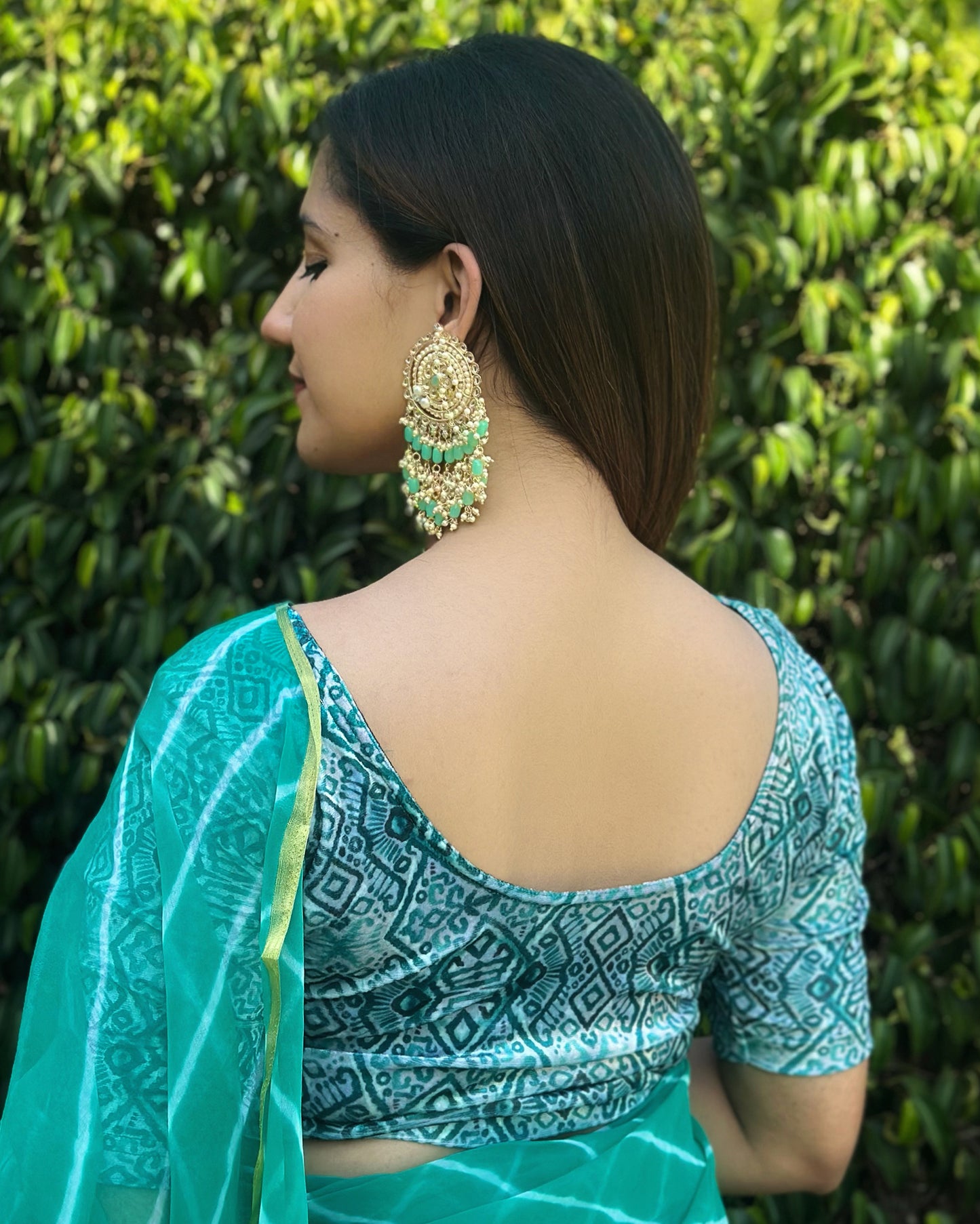 Rear view of the model wearing velvet stretchable blouse showcasing the back design and geometric pattern.