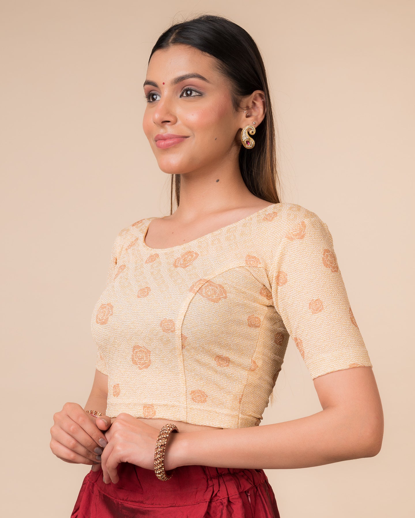Side profile of the metallic zigzag stretchable blouse highlighting the fit and sleeve length.