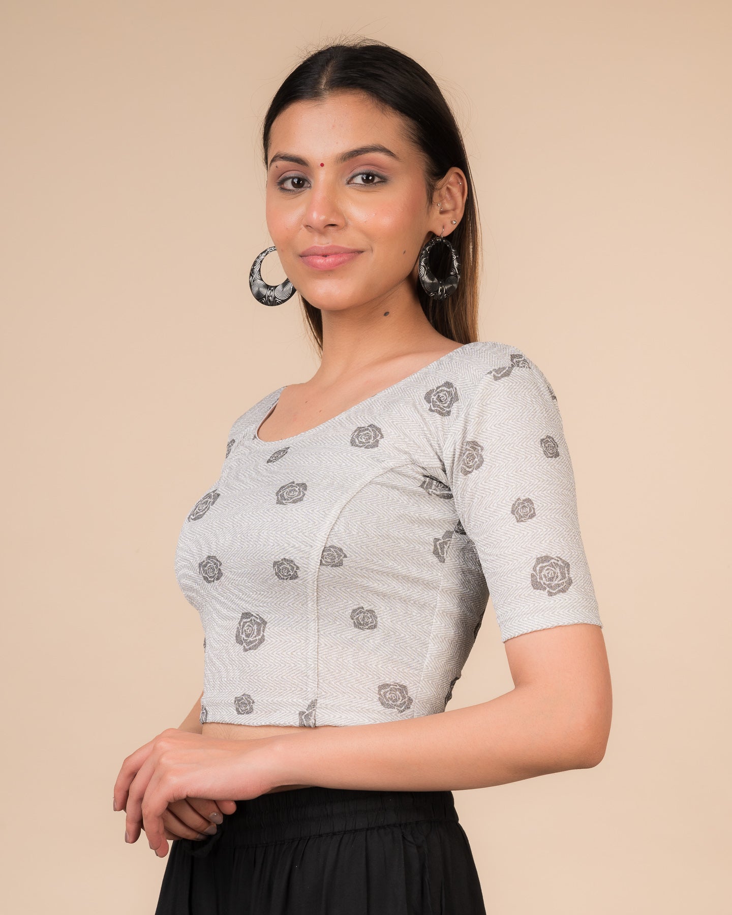Side profile of the metallic zigzag stretchable blouse highlighting the fit and sleeve length.
