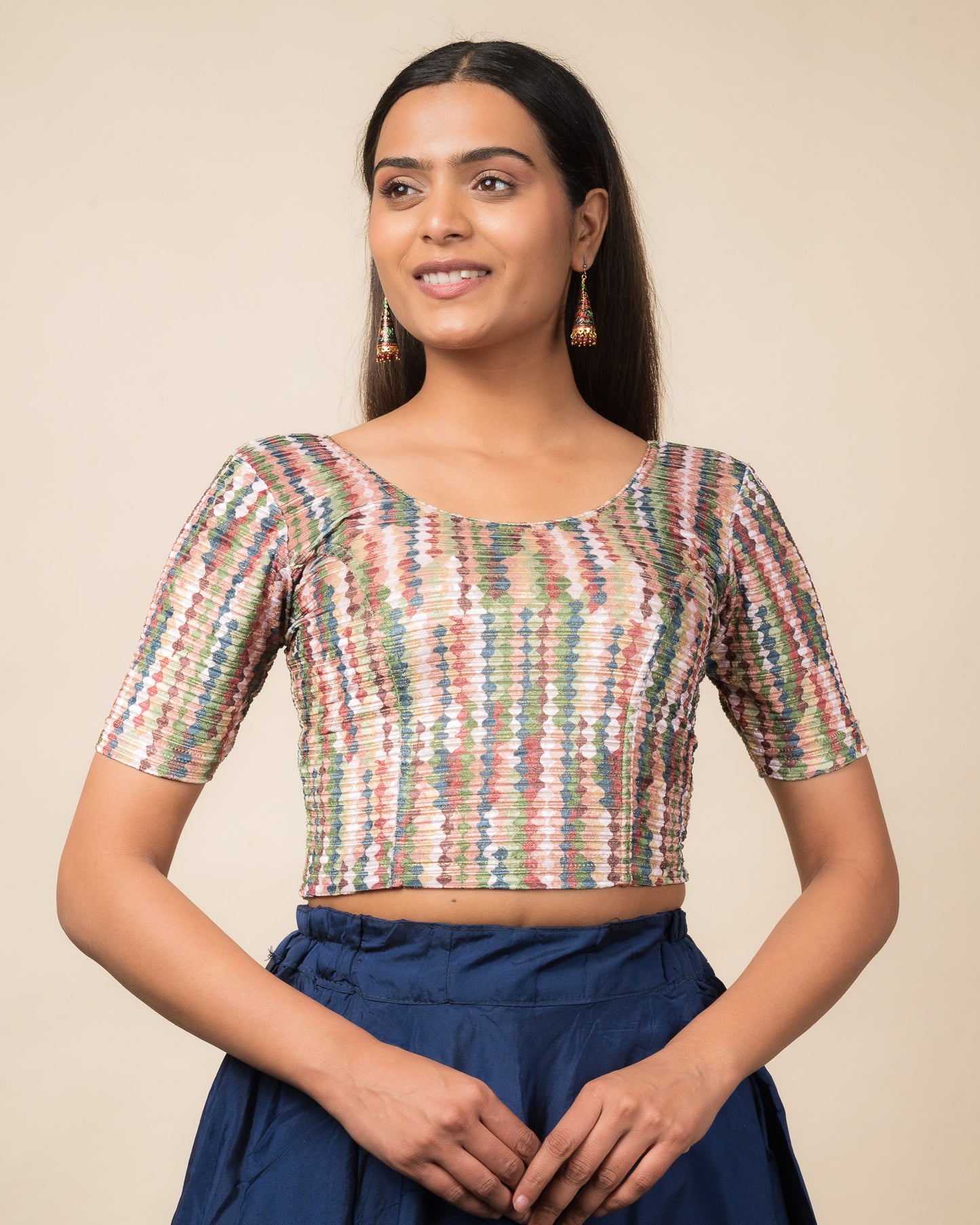 Model wearing a velvet stretchable readymade blouse with elbow sleeves and round neckline featuring modern abstract print.