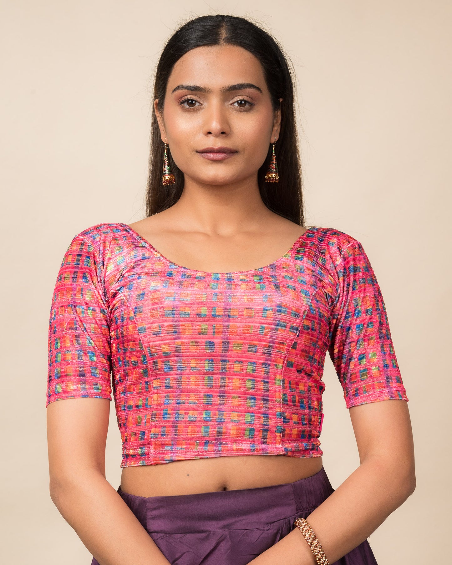 Model wearing a velvet stretchable readymade blouse with elbow sleeves and round neckline featuring modern abstract print.