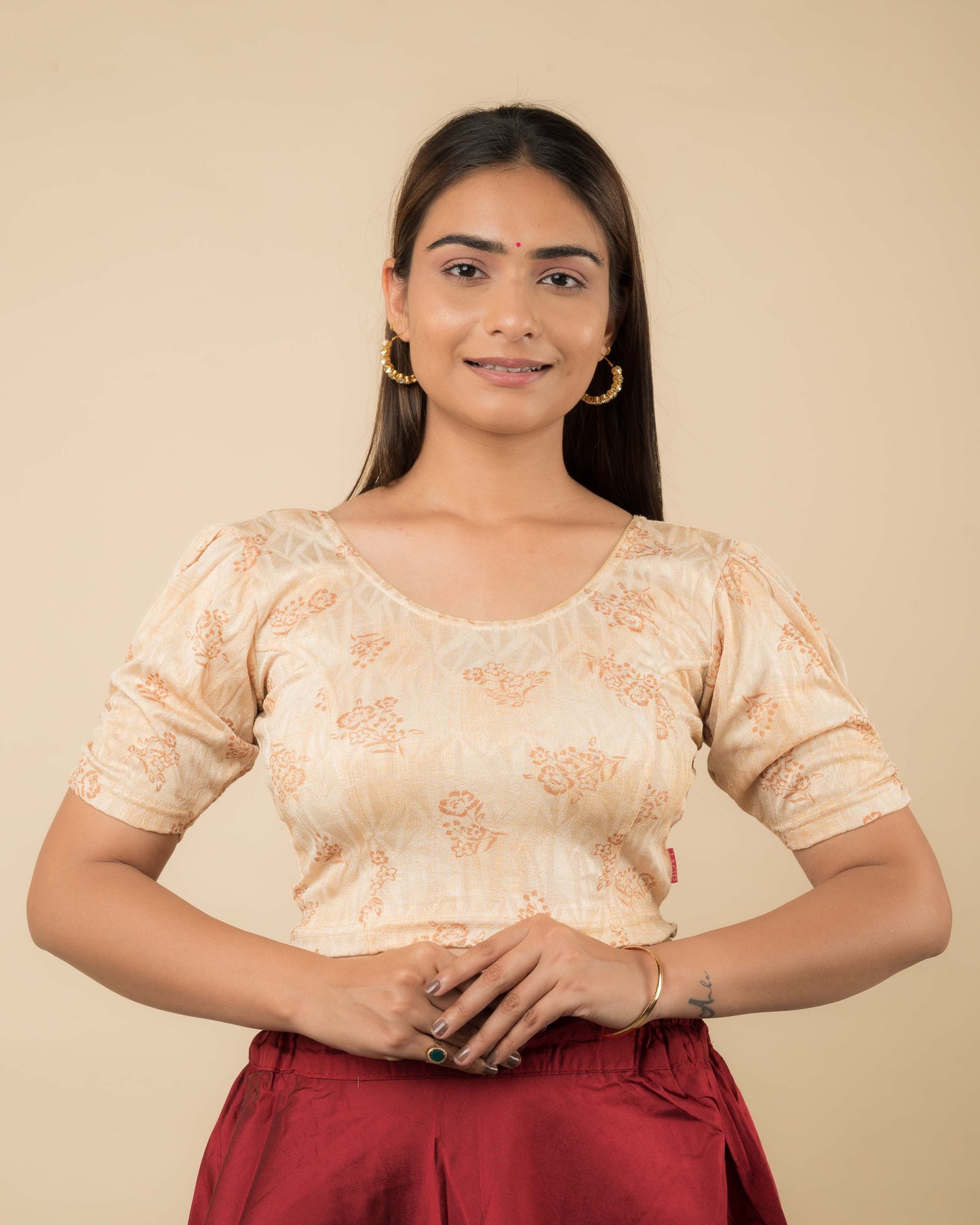 Model wearing a corset-style stretchable readymade blouse with puffed elbow sleeves and round neckline.