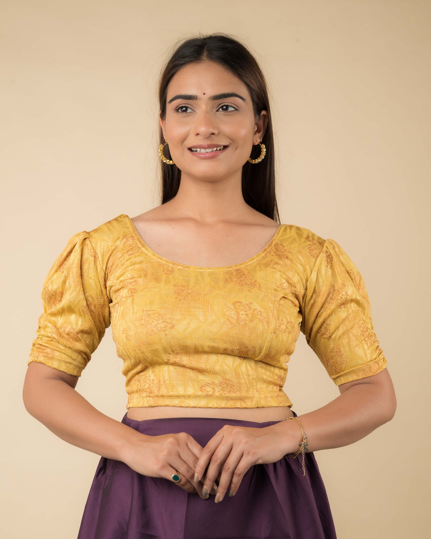 Model wearing a corset-style stretchable readymade blouse with puffed elbow sleeves and round neckline.