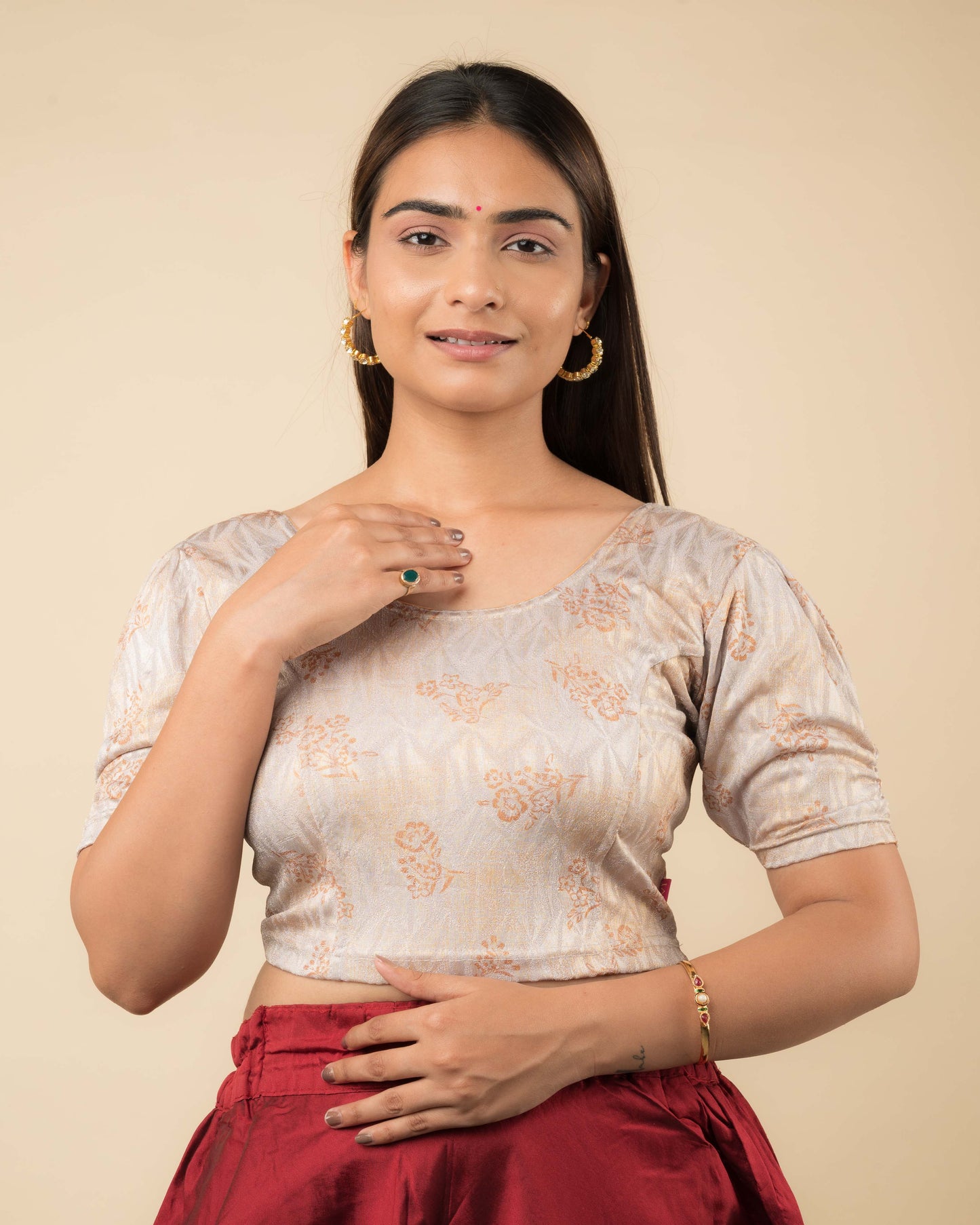 Model wearing a corset-style stretchable readymade blouse with puffed elbow sleeves and round neckline.