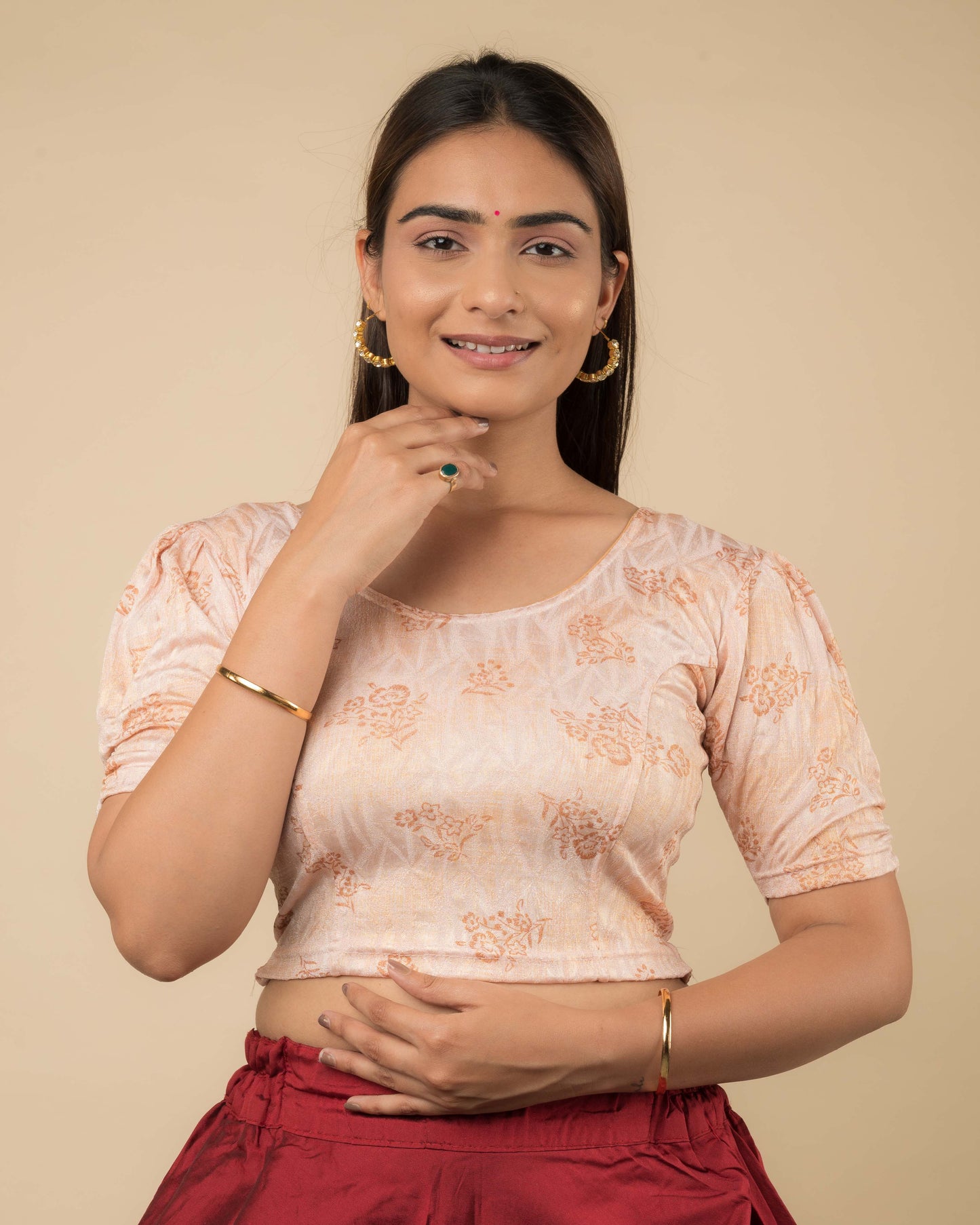 Model wearing a corset-style stretchable readymade blouse with puffed elbow sleeves and round neckline.