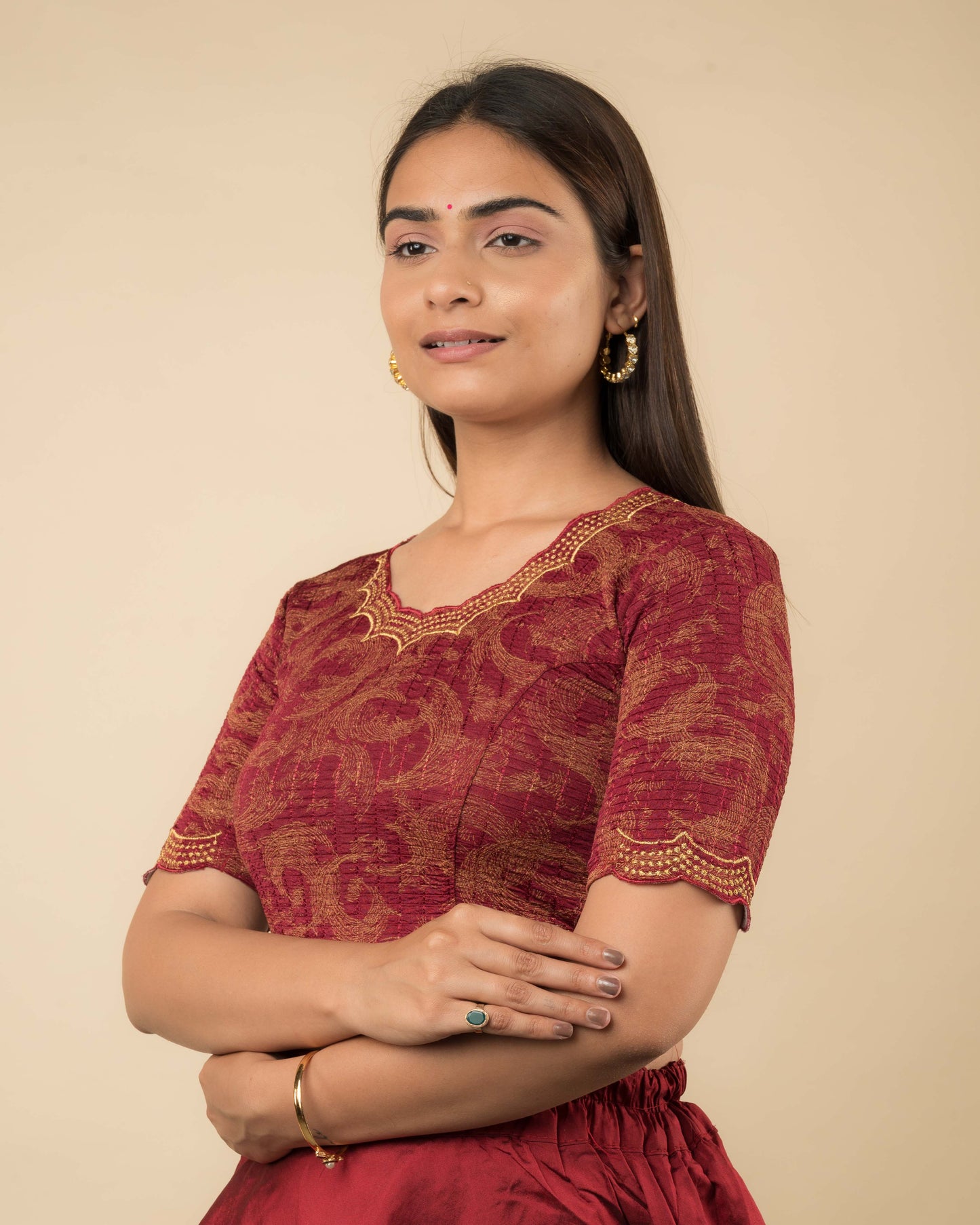 Side profile of the maroon-colored stretchable blouse highlighting the fit, sleeve length, and zari embroidery.